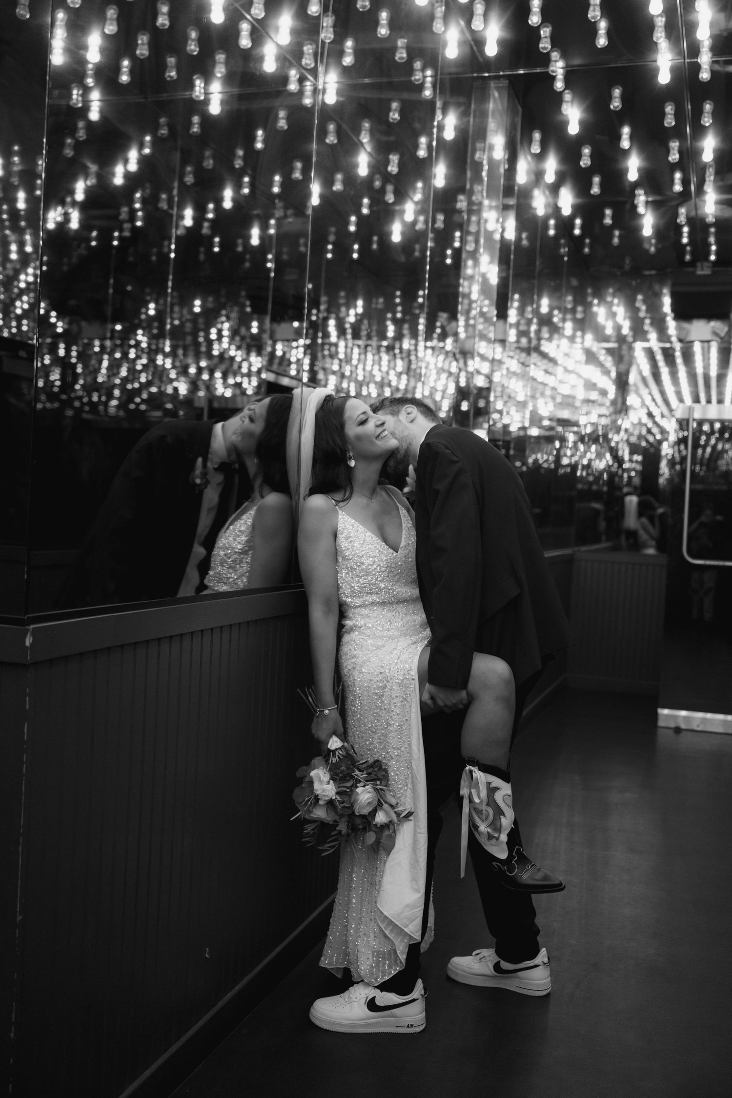 A couple dances under a stunning ceiling of twinkling lights at their wedding reception.