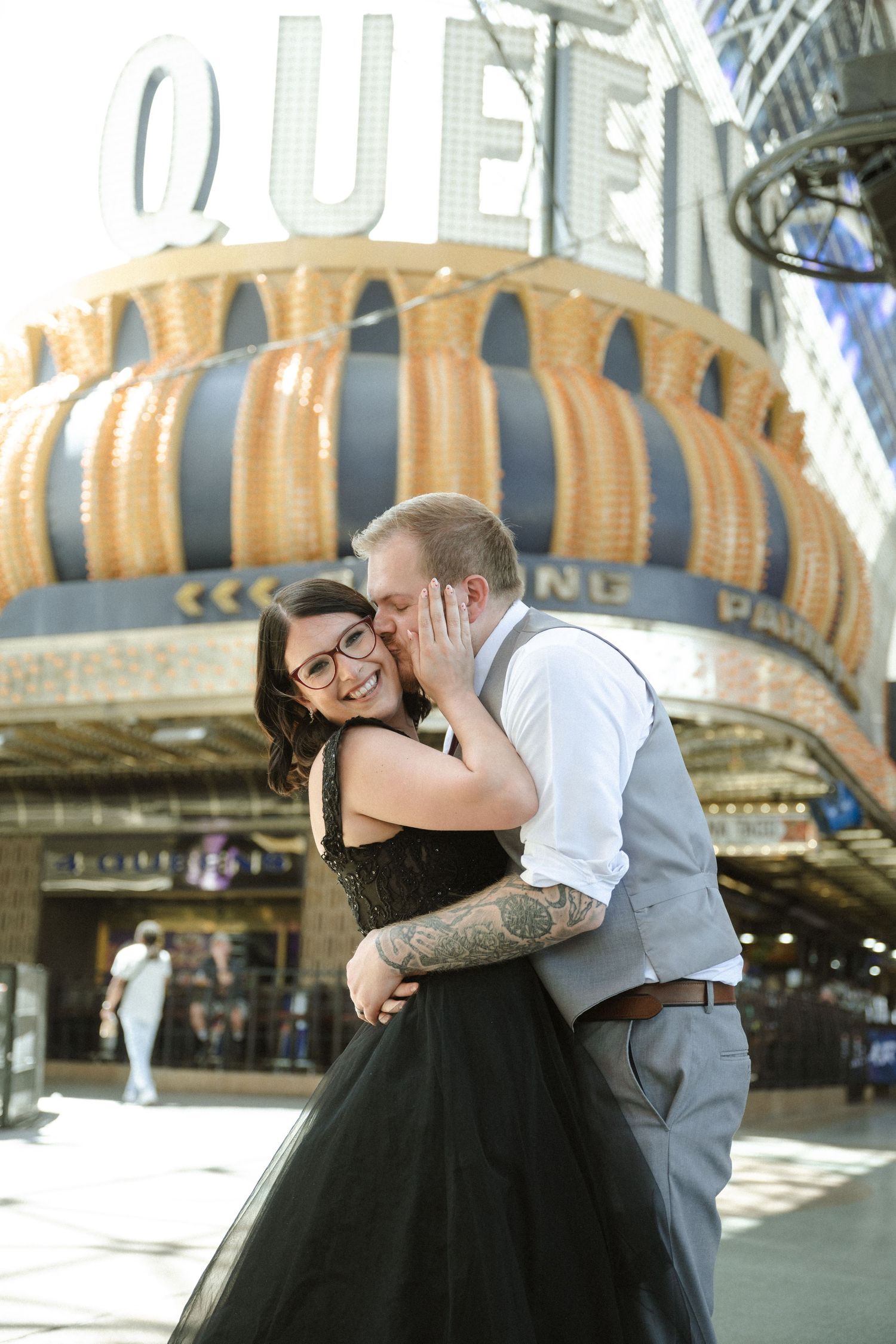 A romantic couple embraces in front of the iconic Golden Nugget casino in downtown Las Vegas.