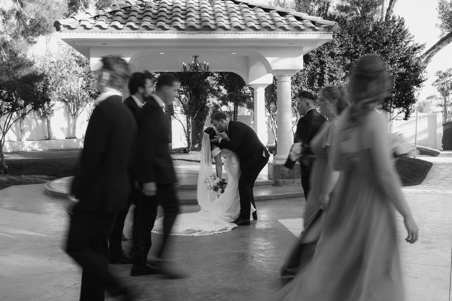 Black and white motion blur captures wedding celebration movement.