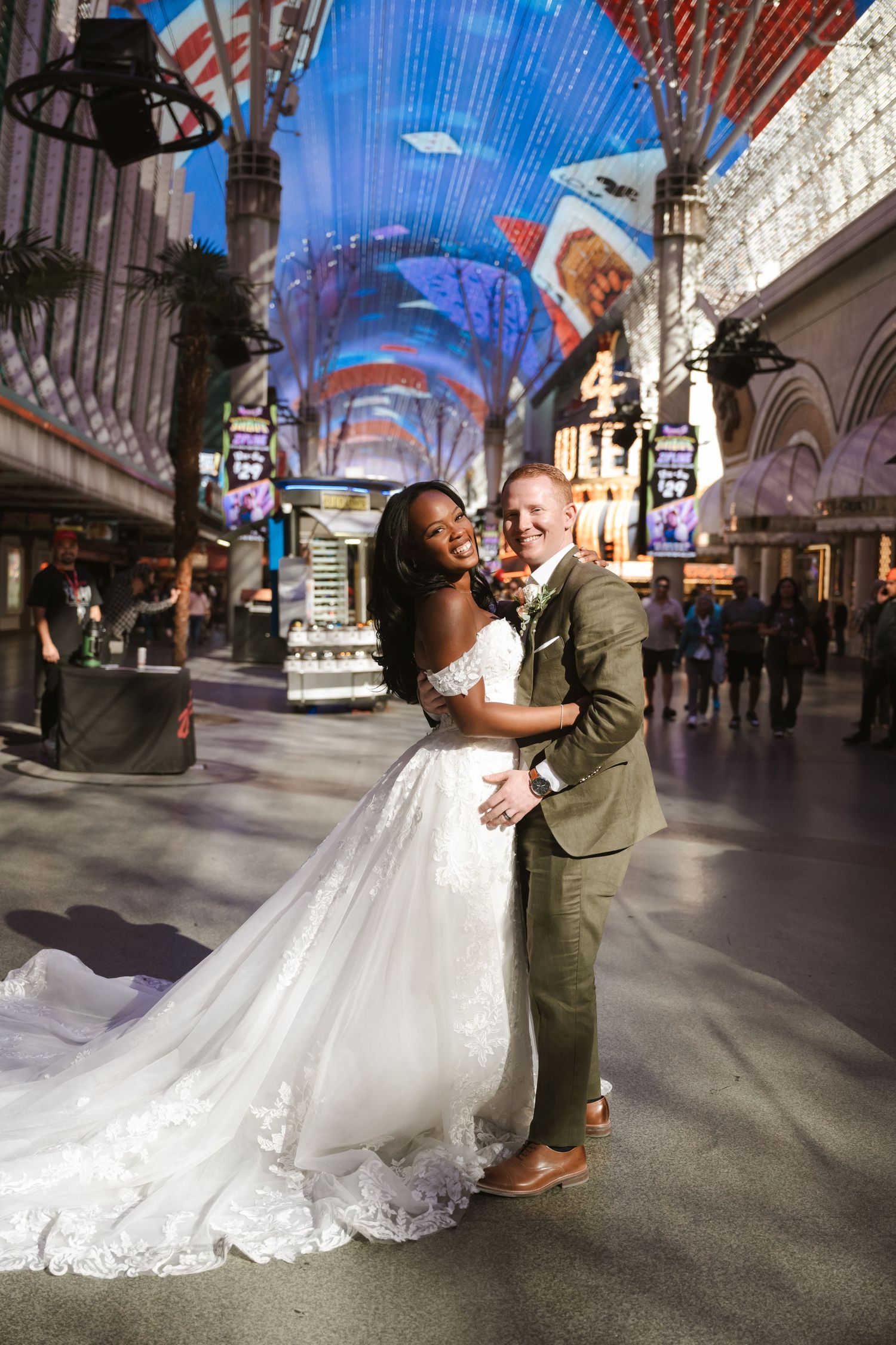 Dynamic wedding photos under Fremont Street Experience LED canopy in Las Vegas.