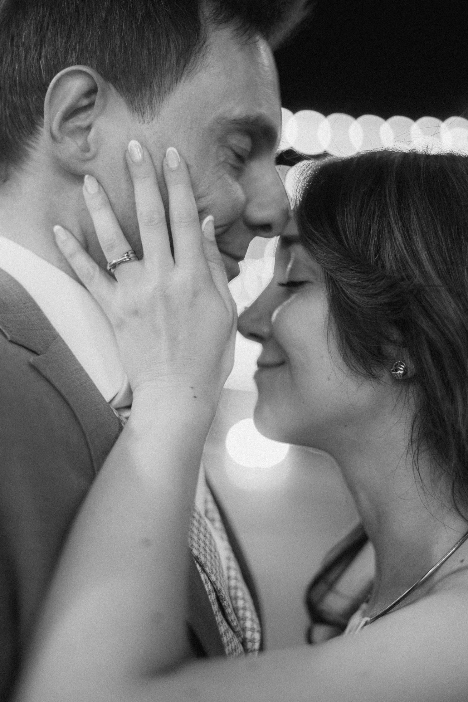 A romantic black and white close-up of a couple sharing an intimate moment.