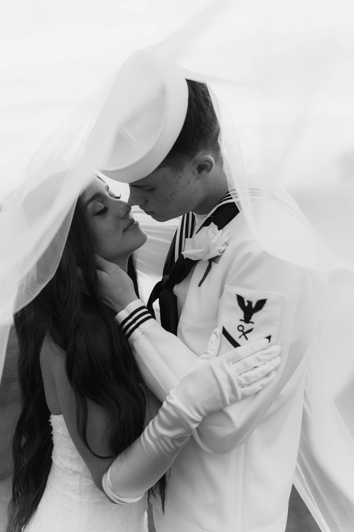 Emotional black and white wedding portraits showing tender moments between bride and military groom.
