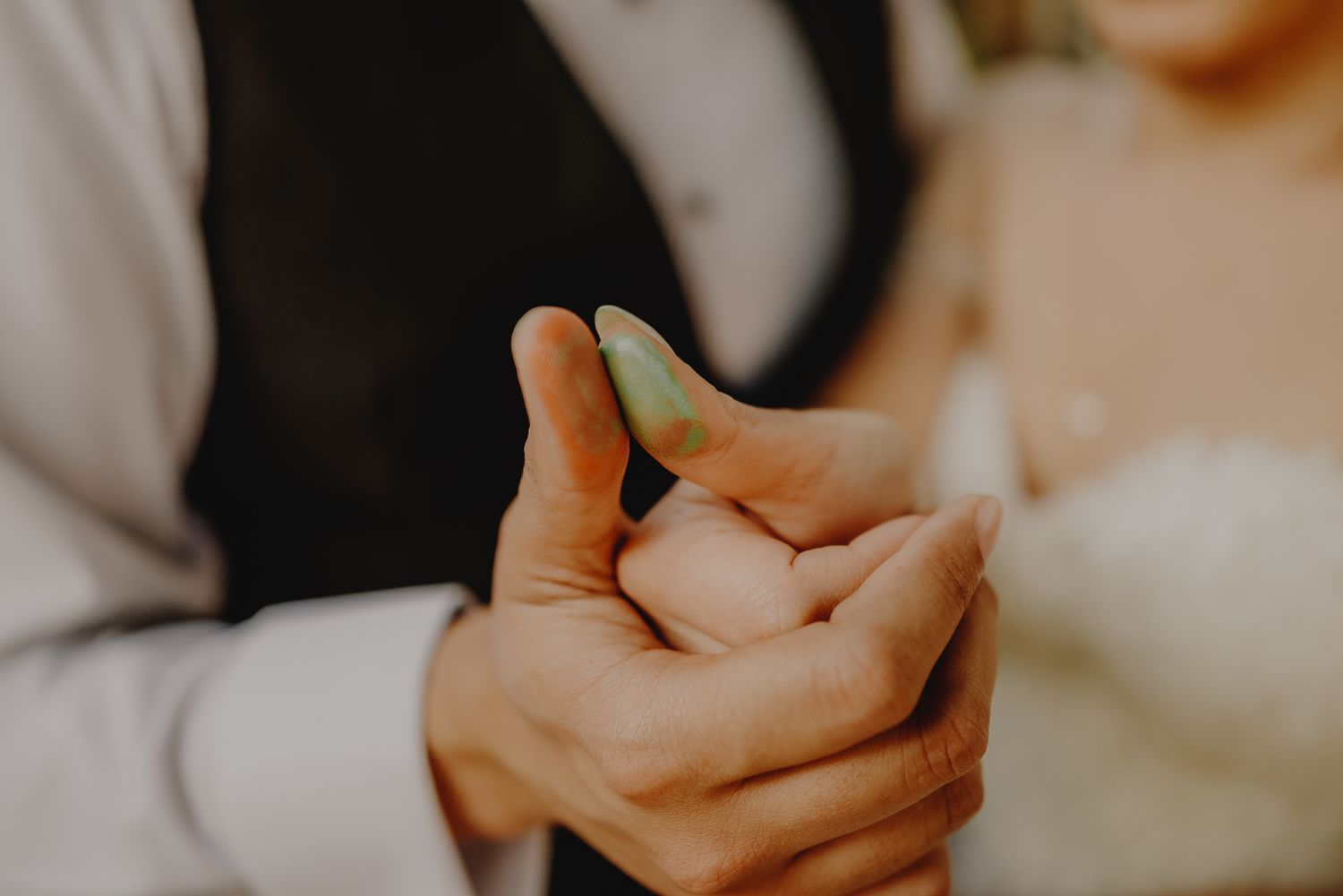 Close-up of hands holding an engagement ring during a proposal.