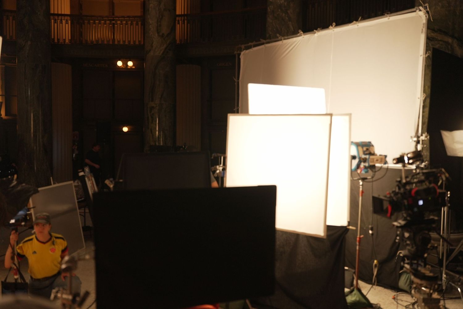 Film production setup with professional lighting equipment in a studio space.