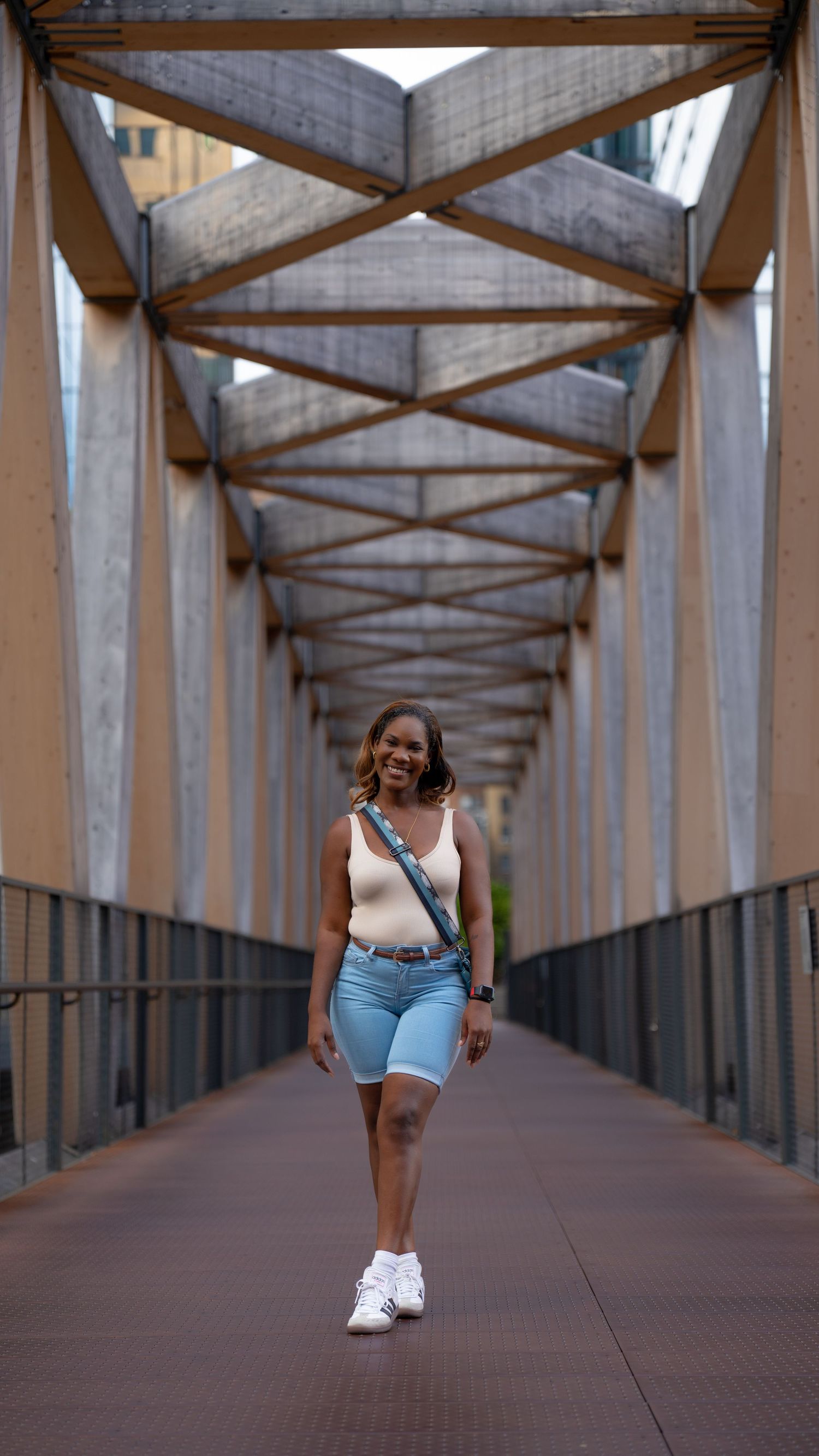 A series of photos showing someone walking along a covered industrial bridge or walkway.