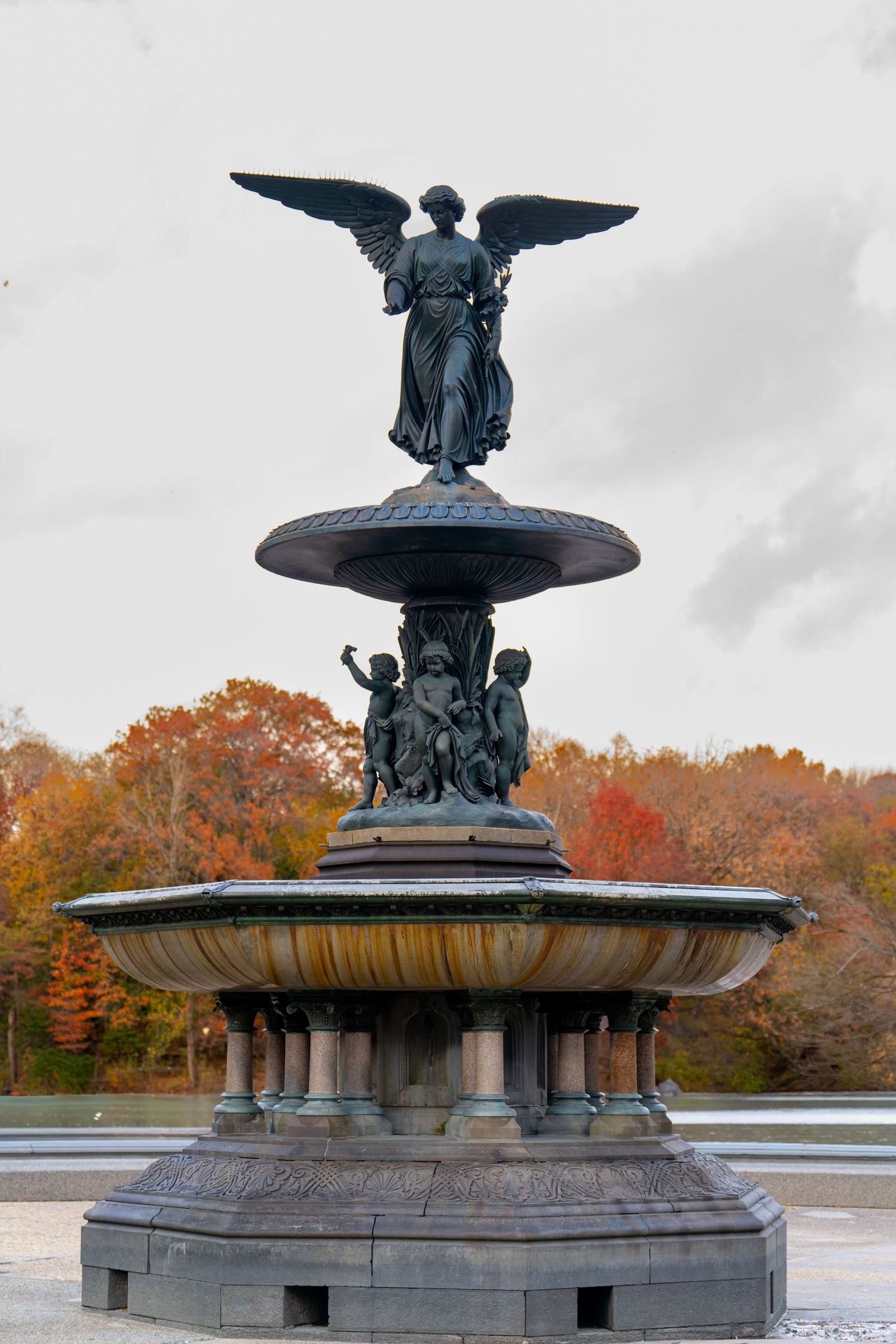 Close-up views of the historic Bethesda Fountain in Central Park showing its ornate bronze angel statue and basin details.