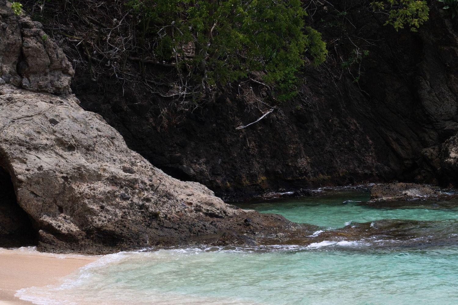 Scenic coastal landscape with rocky cliffs and turquoise water.