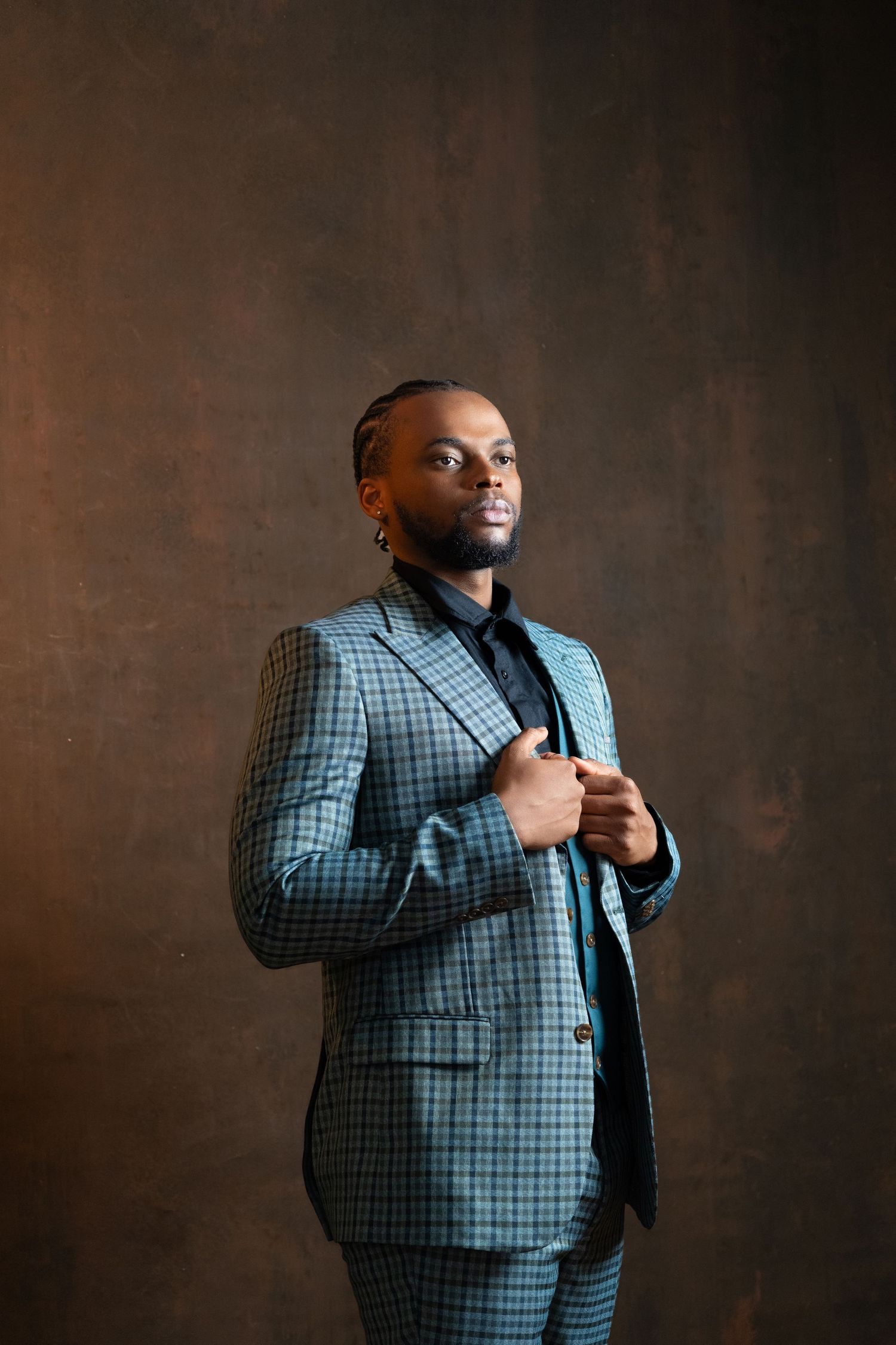 Professional fashion series featuring a plaid suit jacket against a dark brown backdrop.