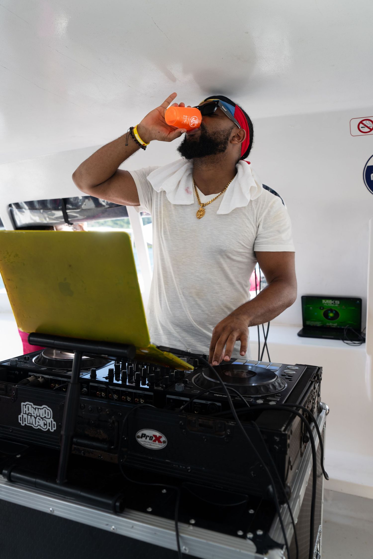 DJ equipment setup with turntables and mixer in white room.