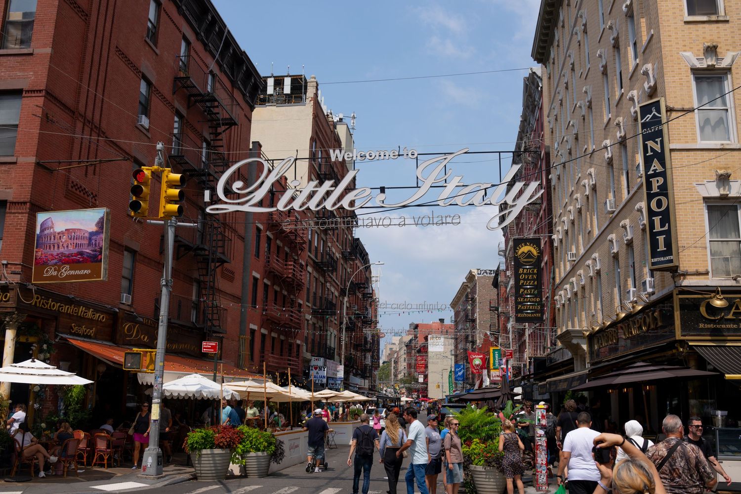 Panoramic view of historic New York City street with classic architecture and pedestrians.