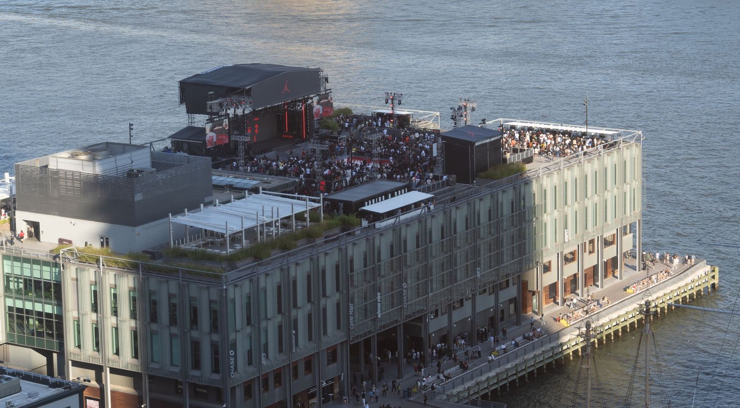 Panoramic view of waterfront buildings and piers along a city harbor.
