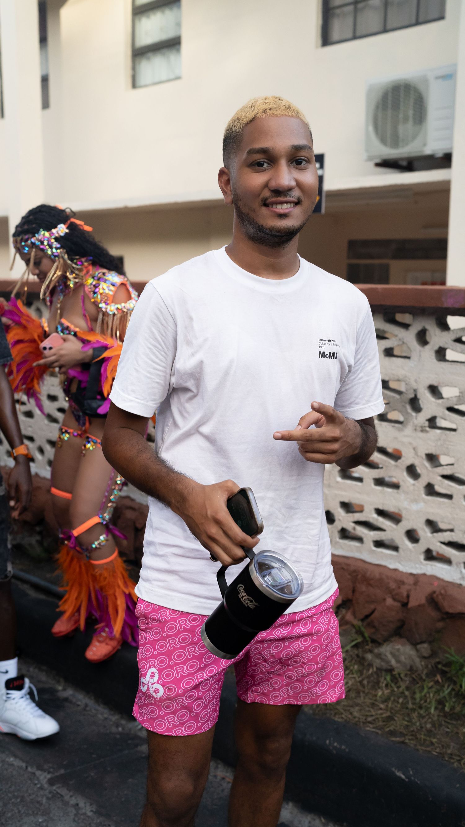 Participants wearing matching white t-shirts and pink shorts at an outdoor event.