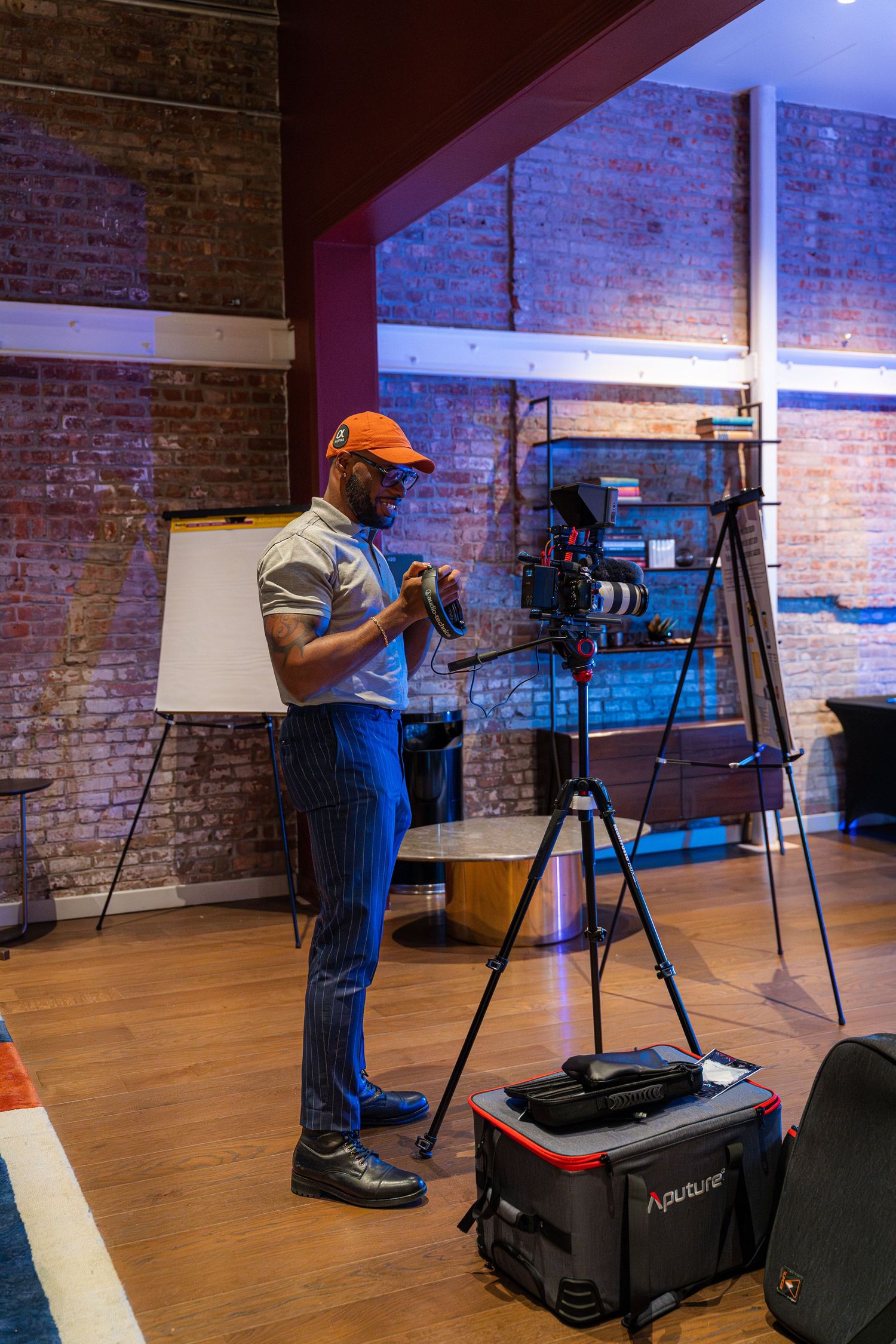 Photography studio setup with equipment and brick walls in industrial space.
