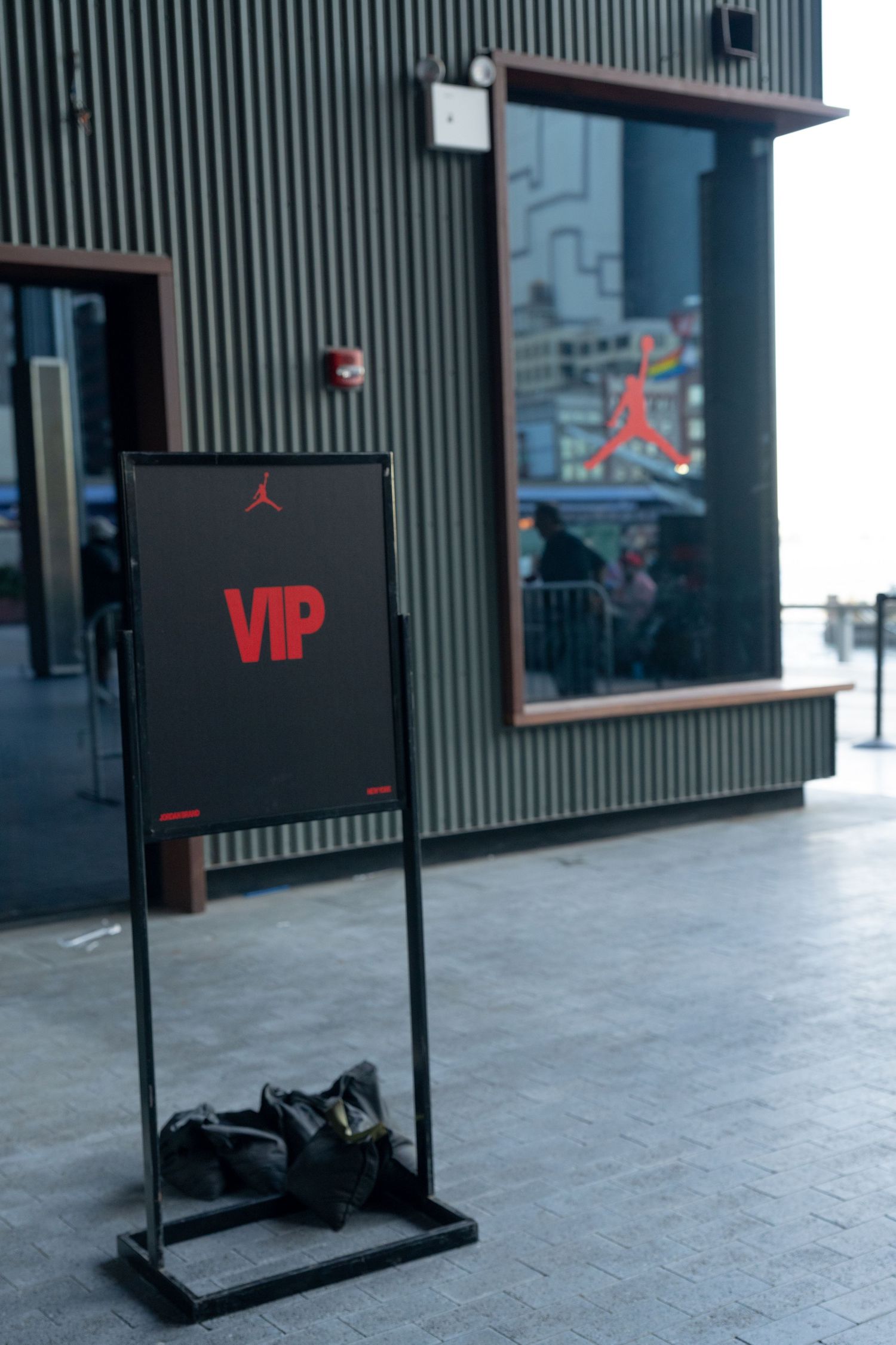 Black VIP sign stand displayed on gray concrete floor outside a building.