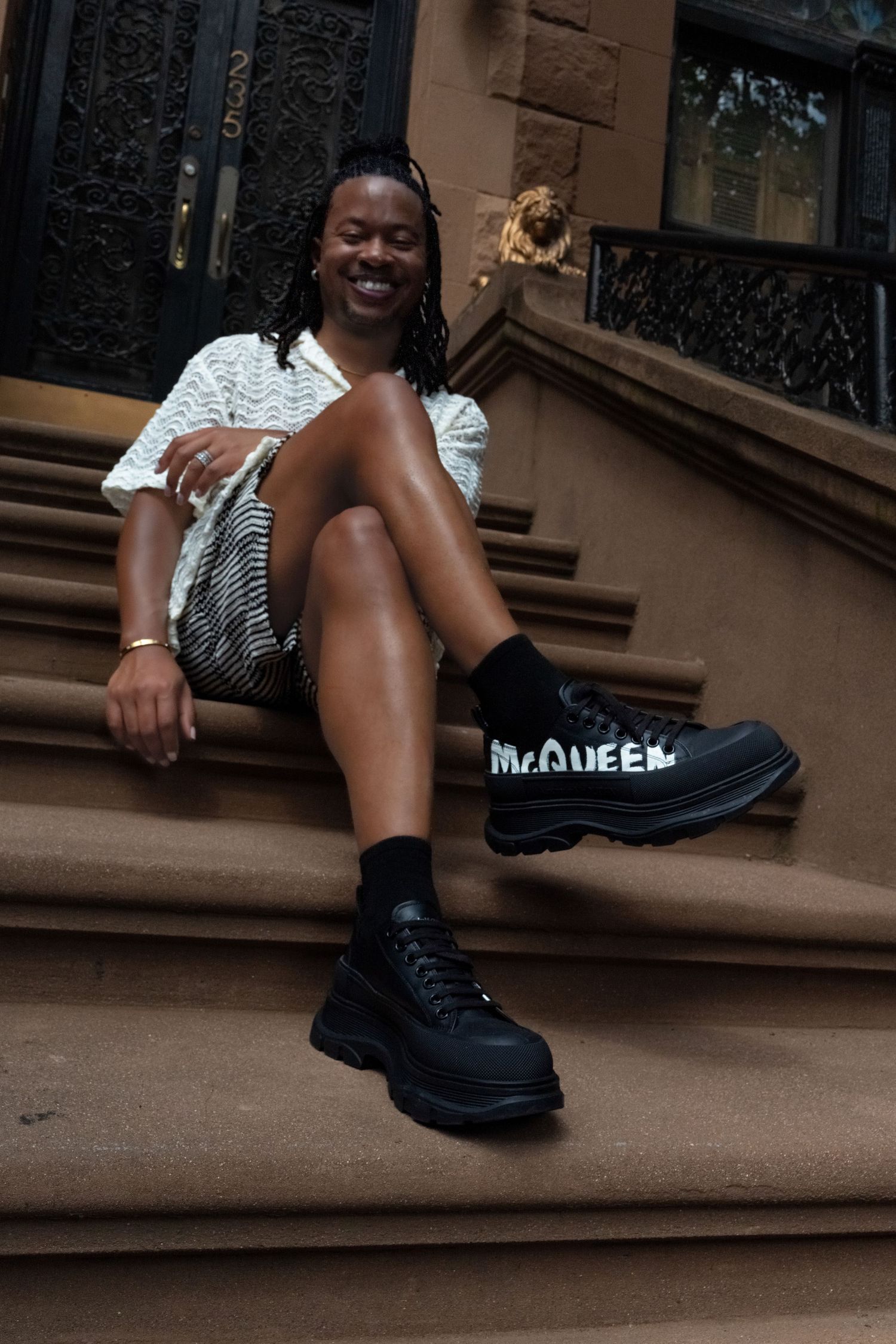 Black platform boots shown on brown concrete steps in natural lighting.