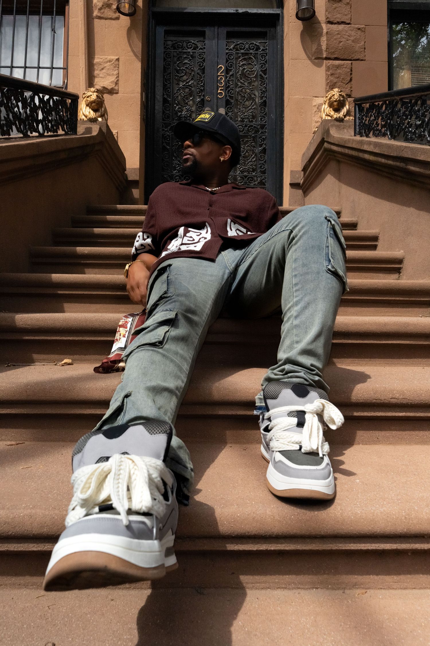 Close-up view of gray sneakers on brown stone steps.