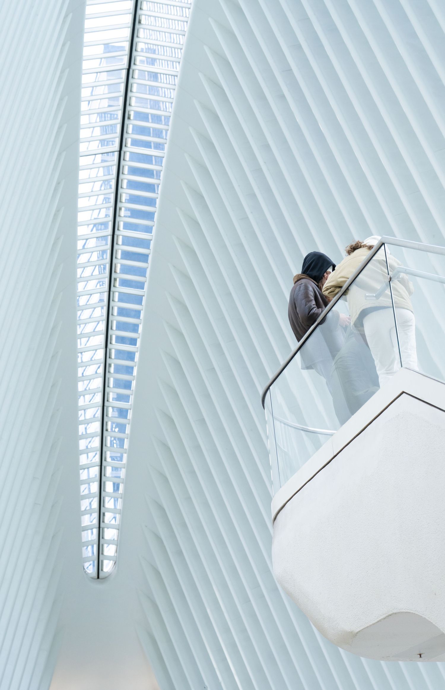 A sequence of images showing a person climbing up a white architectural structure with angled lines and modern design.