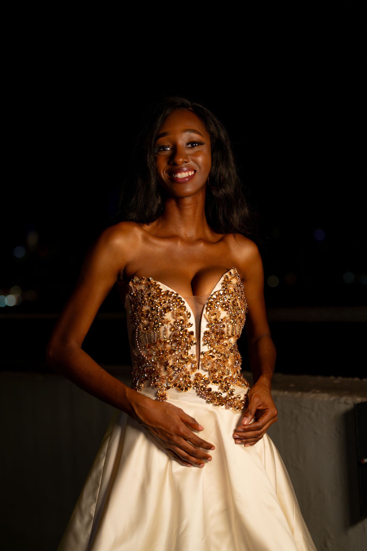 Elegant strapless gown with gold sequined bodice and white skirt.