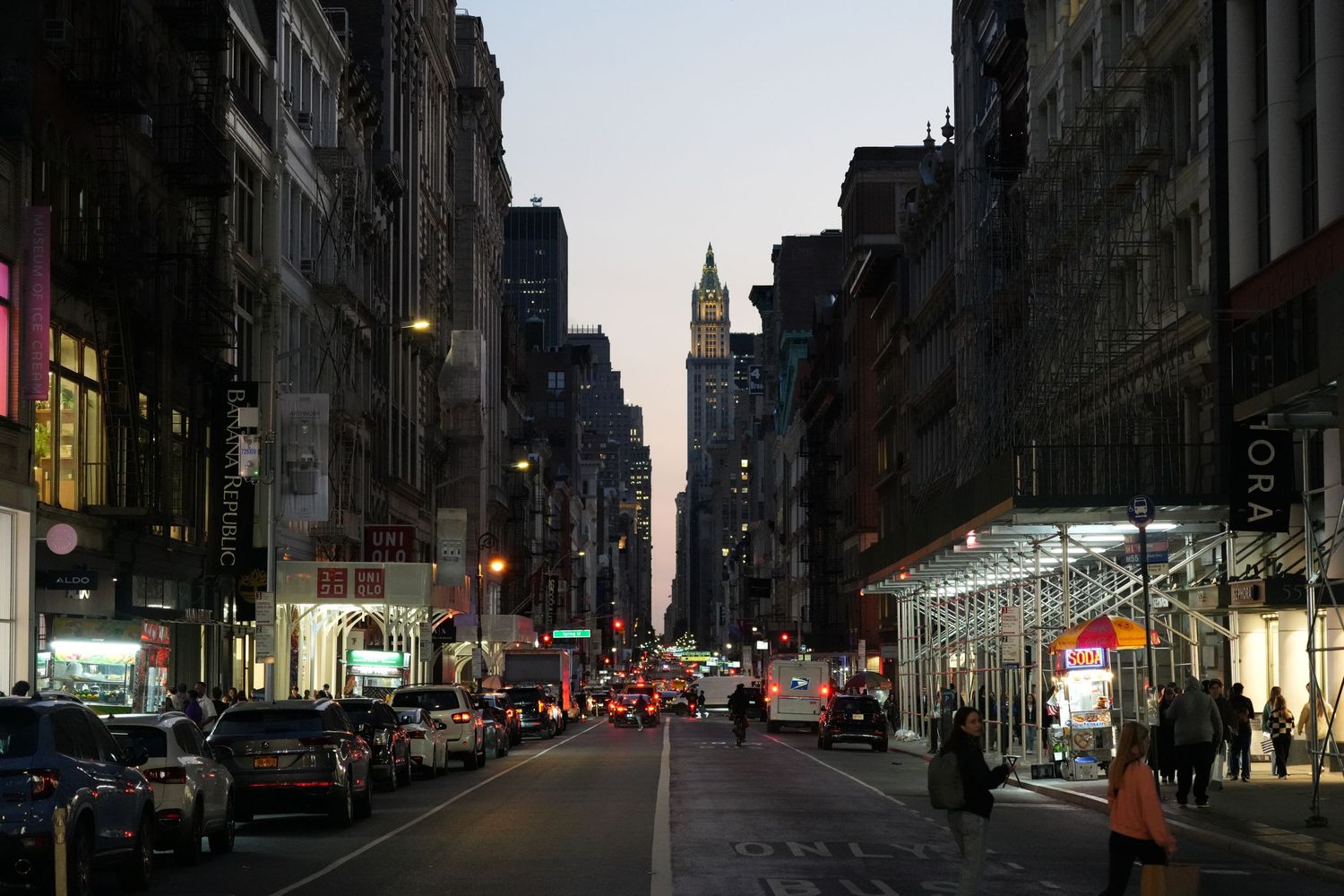 Urban street view of darkened city buildings during power outage or dusk.