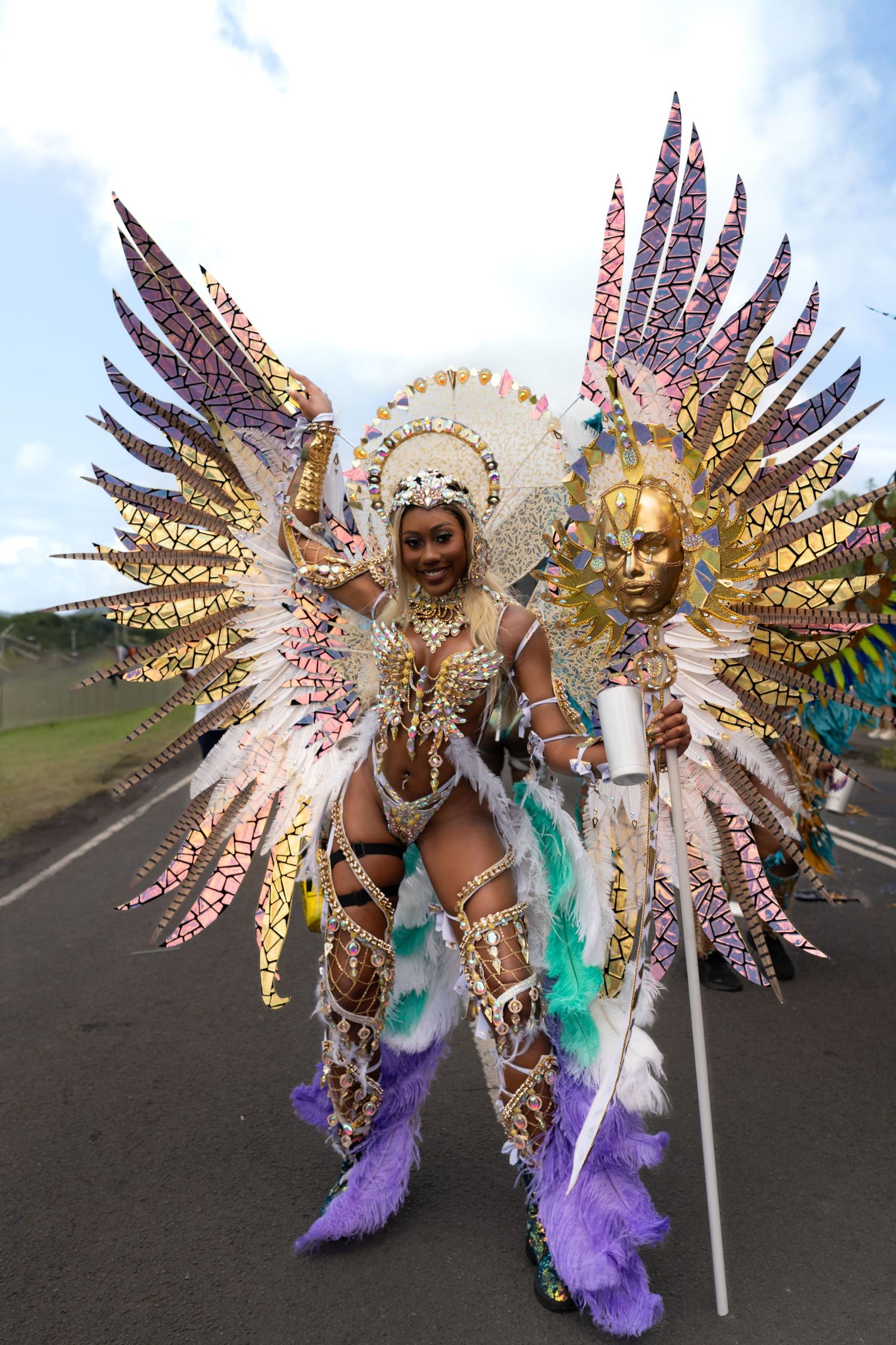 Carnival performer wearing an ornate gold and white winged costume.