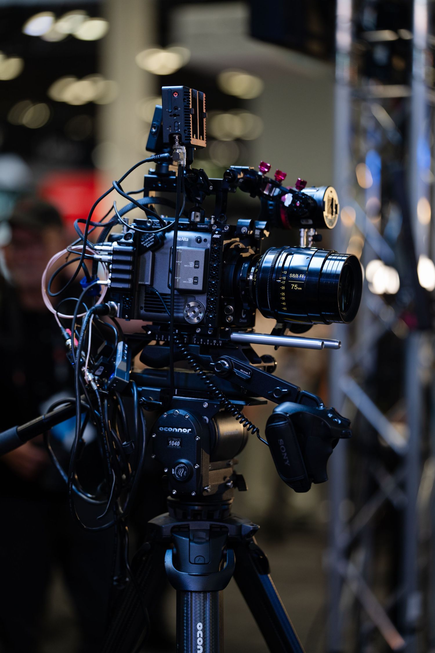 Close-up of professional video camera equipment with multiple attachments.