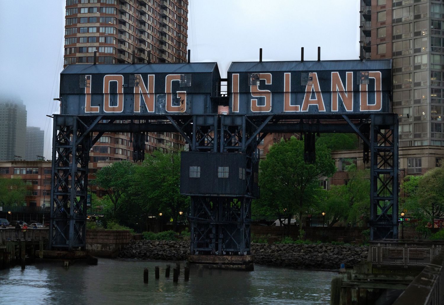 Panoramic view of Long Island City waterfront with historic industrial buildings and modern towers.