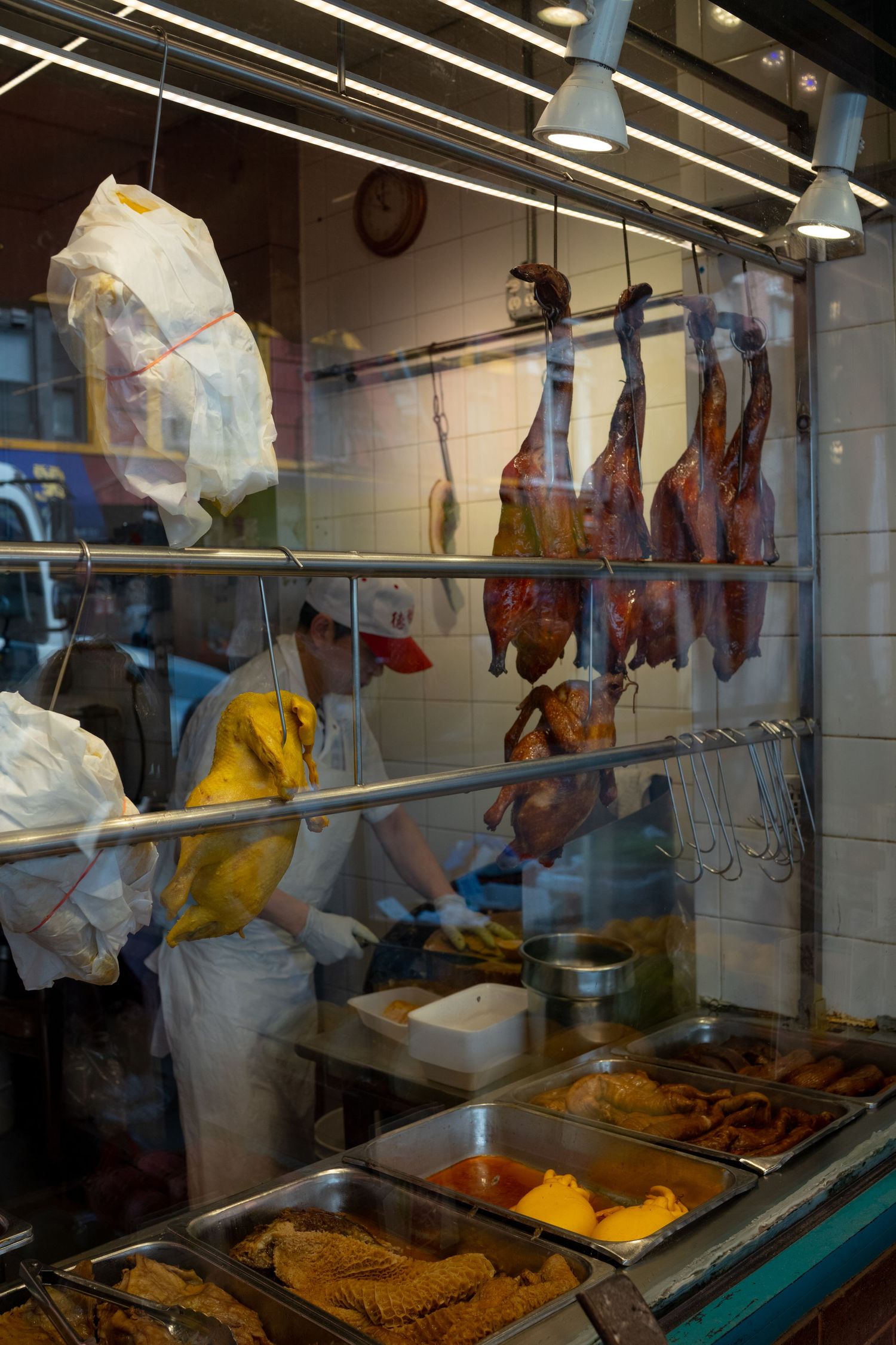 Food service counter with display case showing prepared dishes under bright fluorescent lighting.