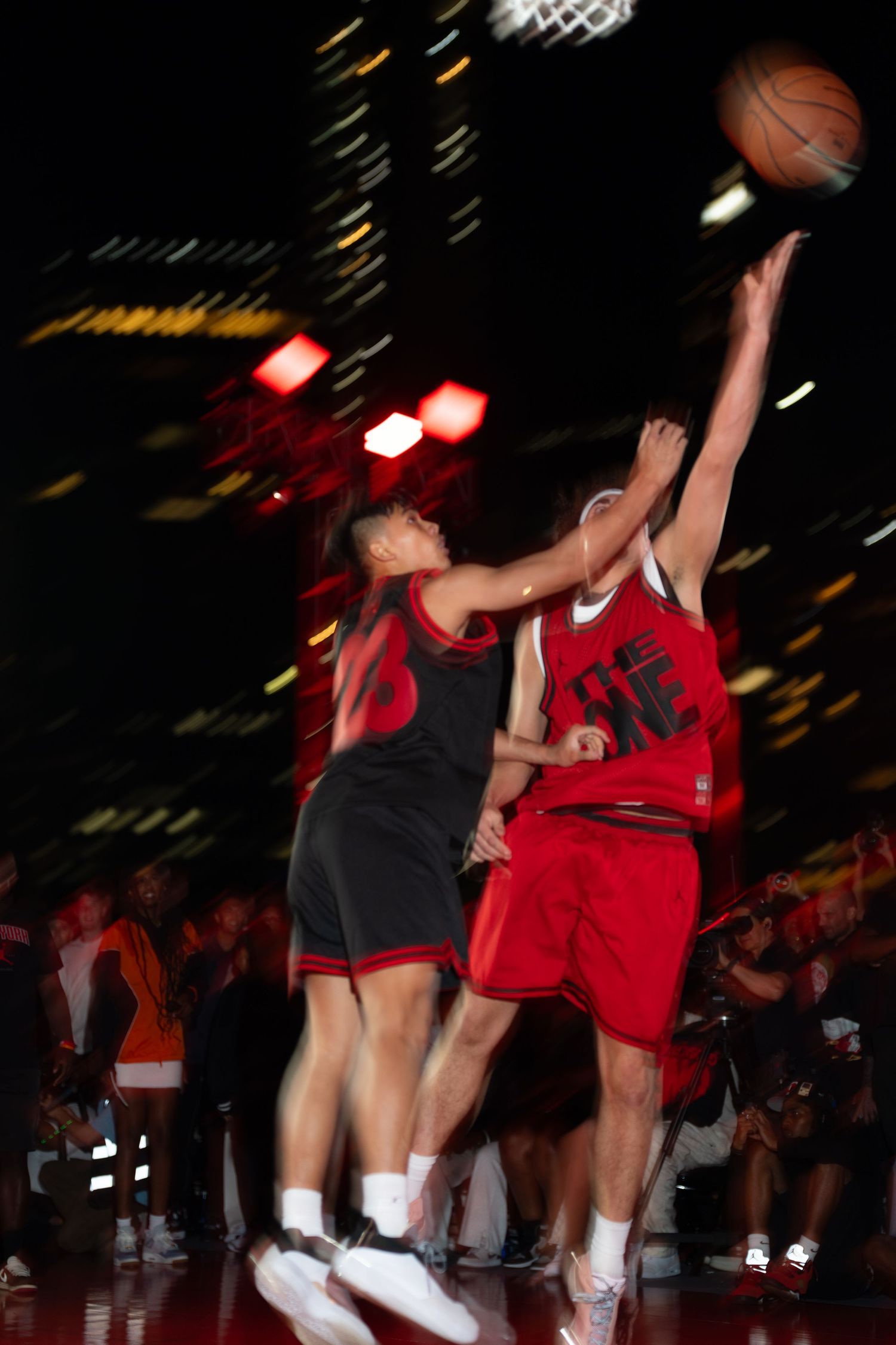 Basketball players in action during a game with motion blur effects.