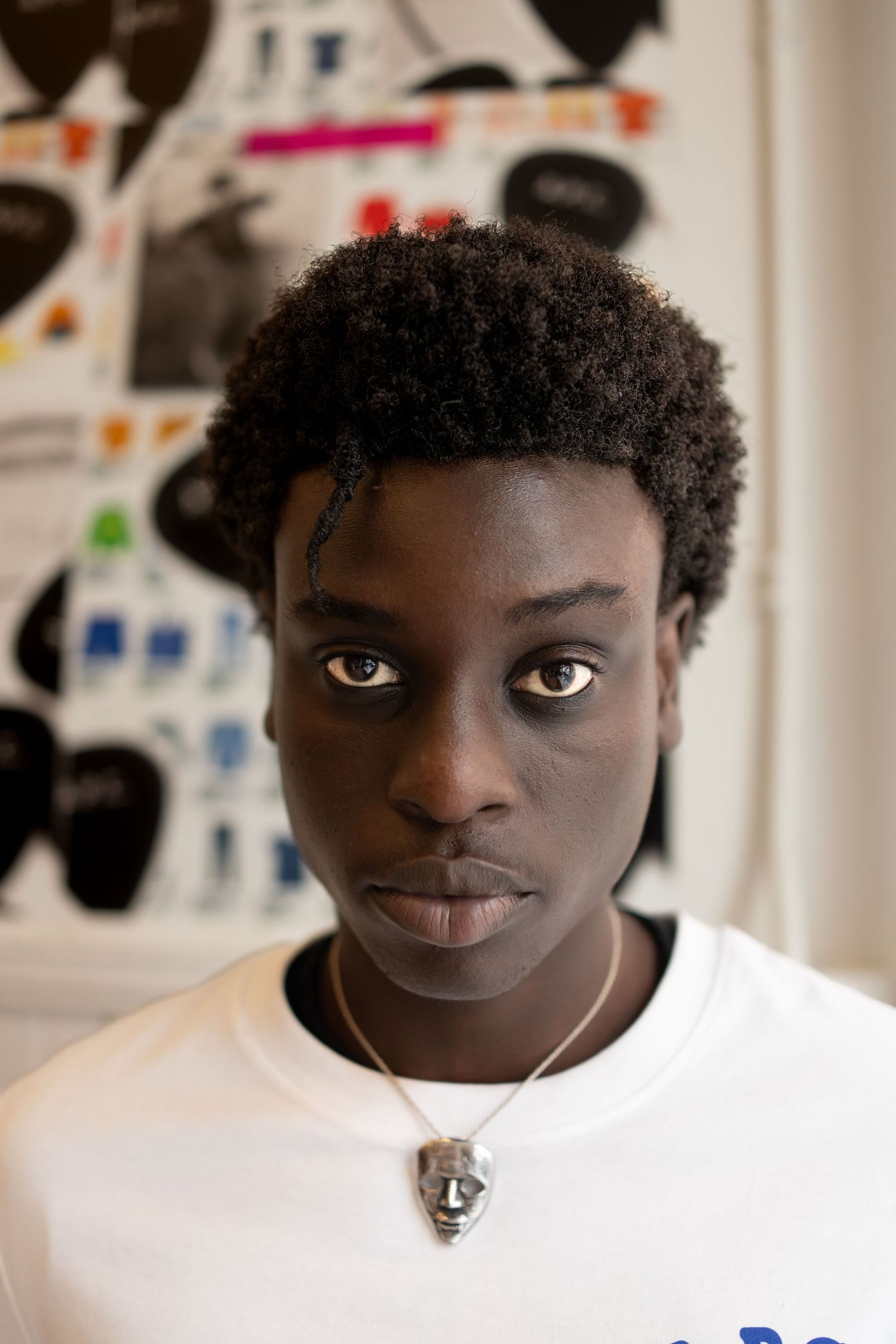 Close-up portrait showing expressive eyes and facial features against a light background.