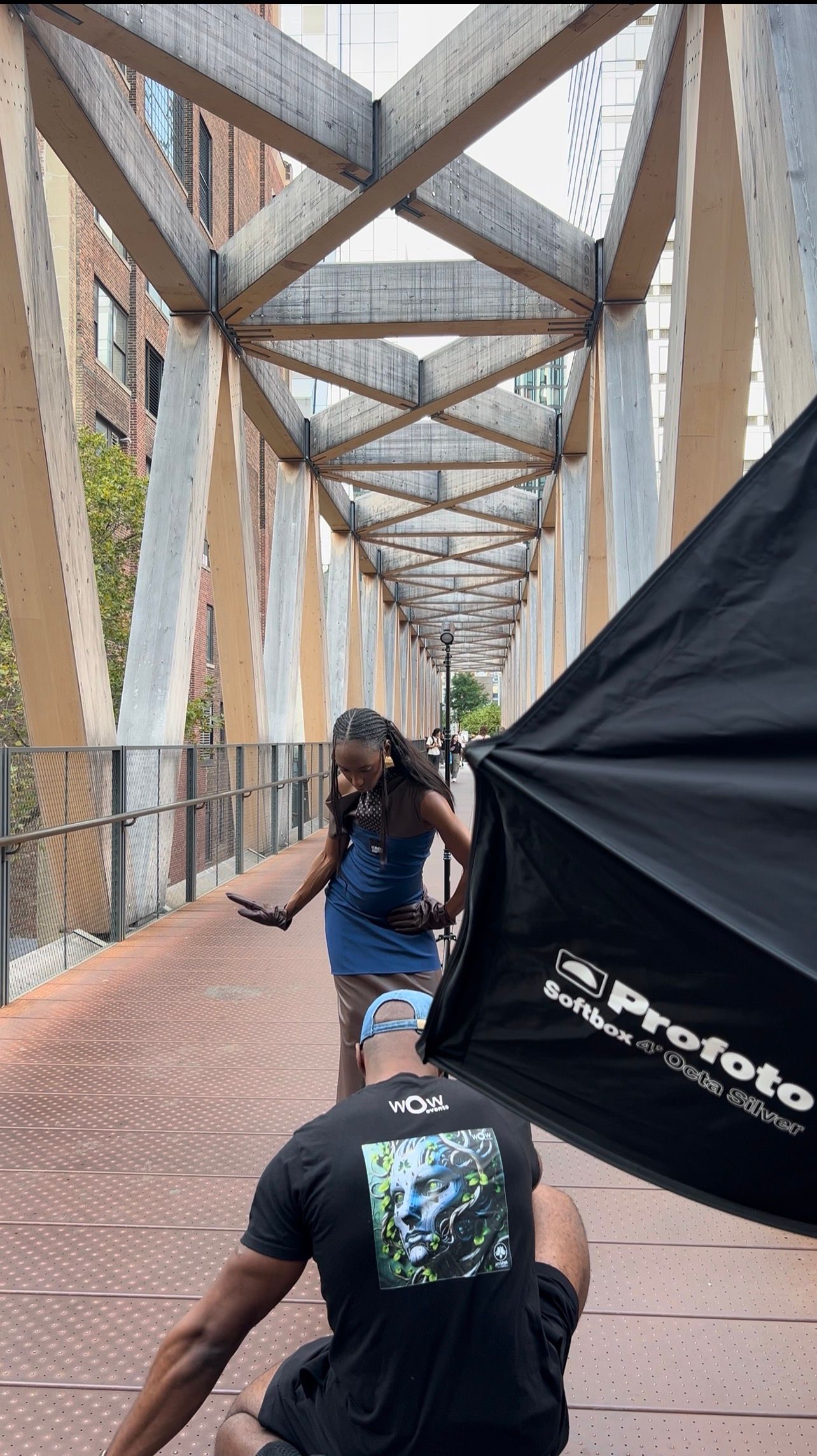 Photographers with Profoto gear shooting under geometric architectural covering.