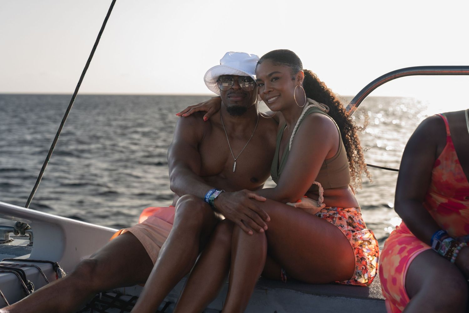 Friends enjoying leisure time on boat deck during sunset cruise.