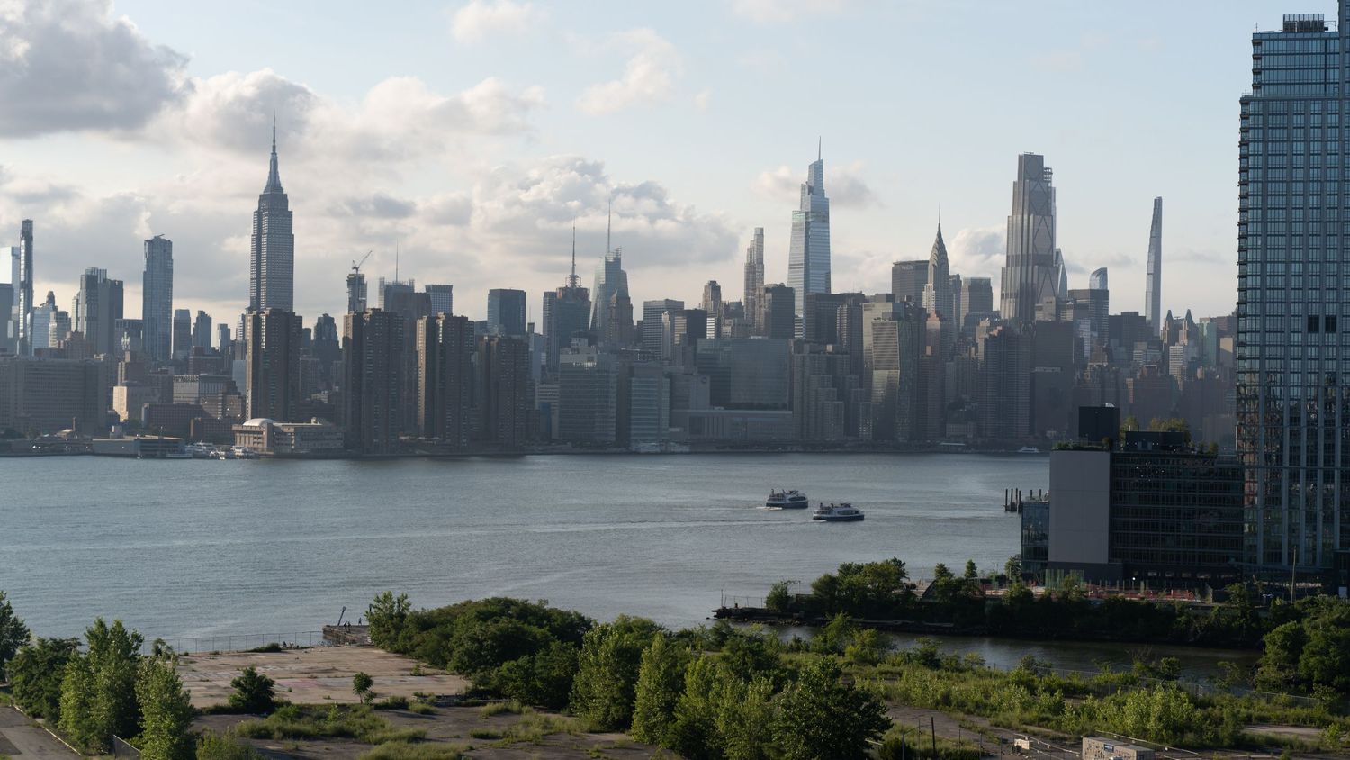 Panoramic skyline of Manhattan showing iconic skyscrapers along the waterfront.