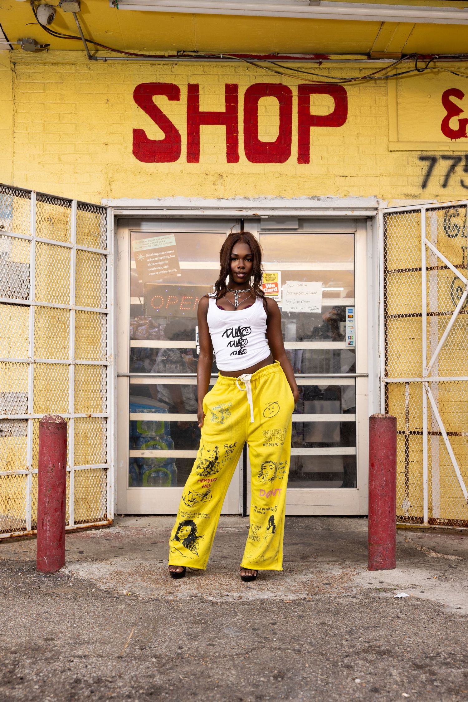 Yellow painted storefront with person wearing bright yellow pants.