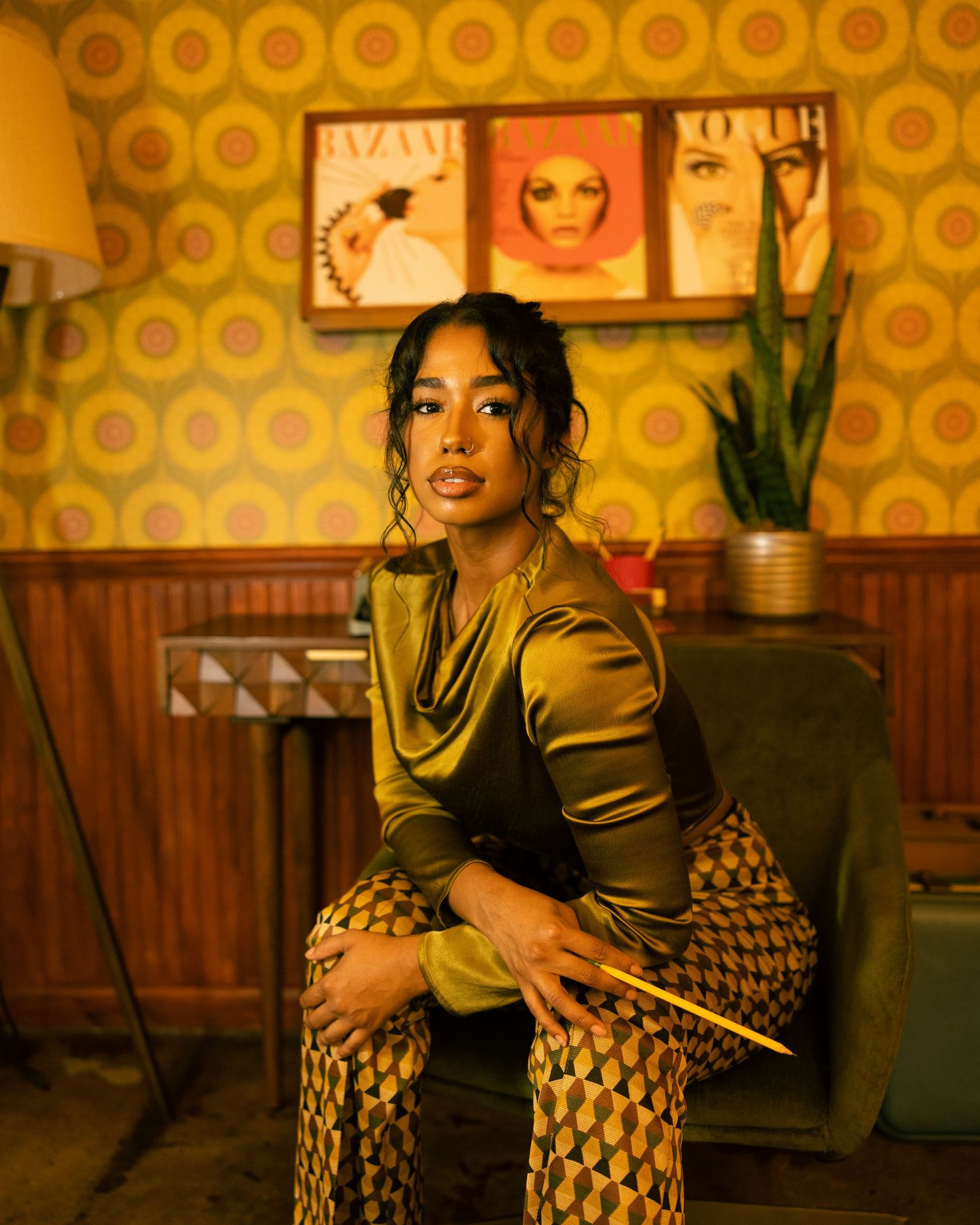 Artistic portrait session in retro-styled room with yellow wallpaper and wooden paneling.