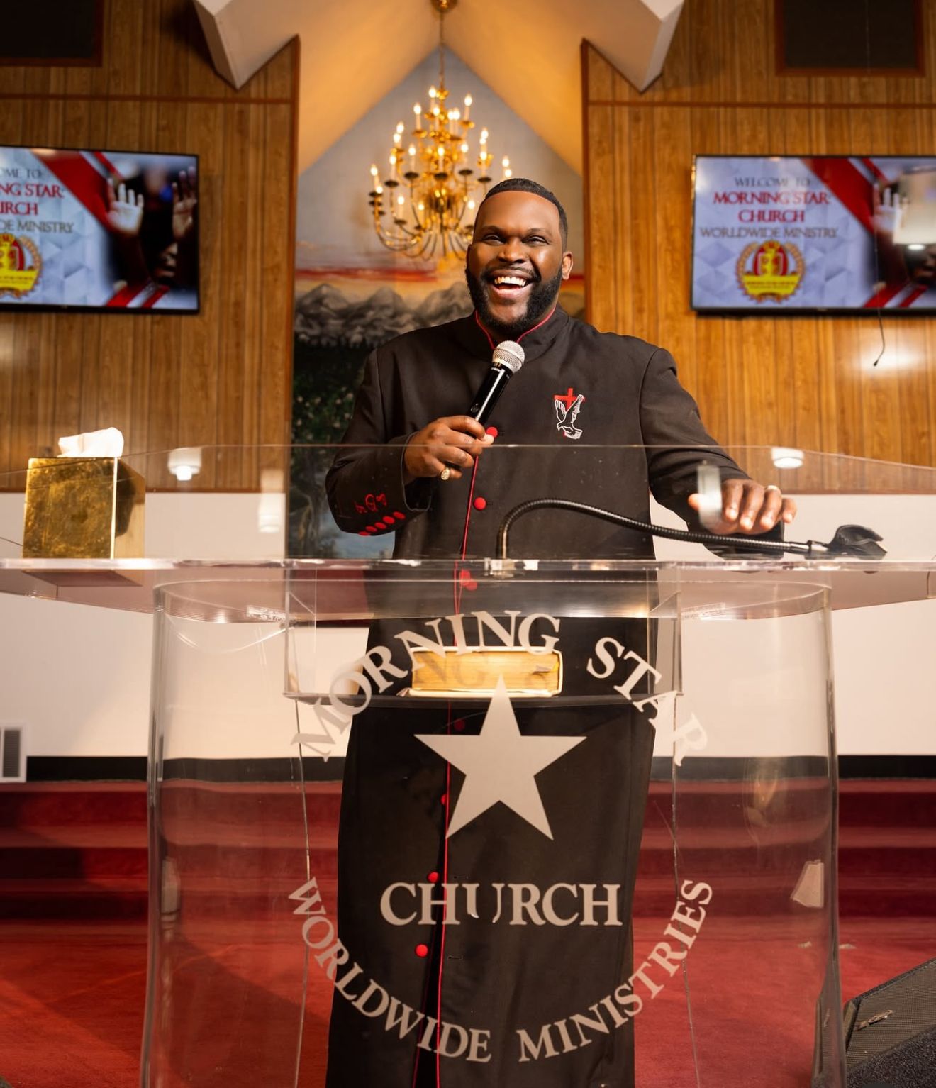 Speaker presenting at a church podium with illuminated decor.