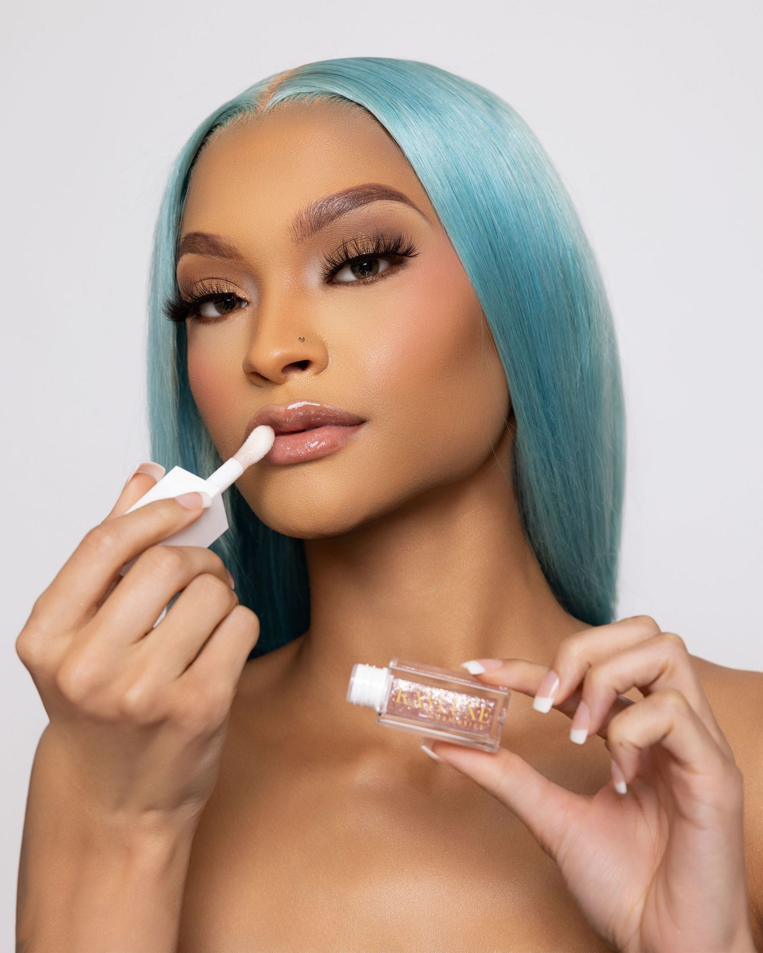 Beauty product application shots featuring blue hair and natural makeup against white background.