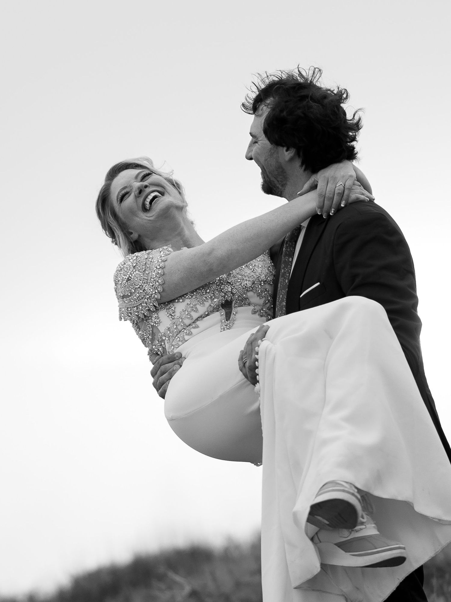 Black and white groom lifting the laughing bride at an adventure elopement, by Sammy Aucella Photography