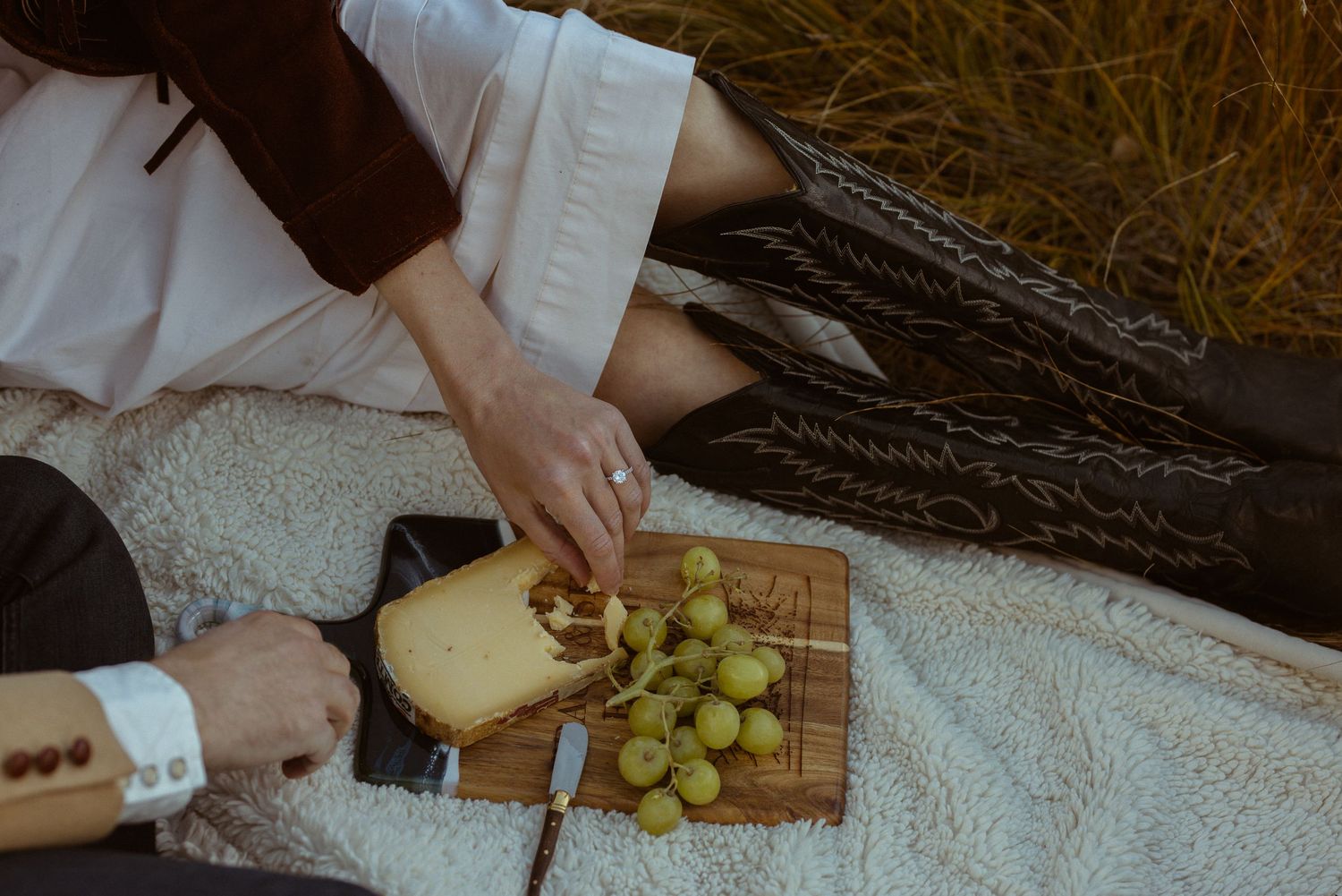 Styled charcuterie board with grapes and cheese during Ashcroft Ghost Town Aspen Colorado engagement session by Sammy Aucella Photography
