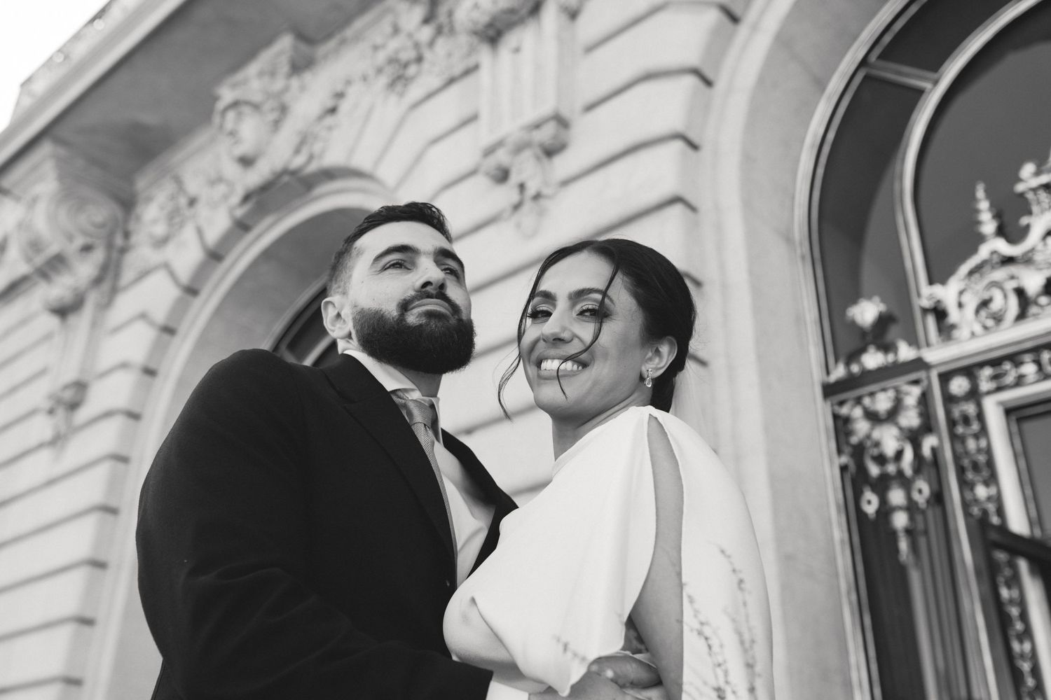 Outside San Francisco City Hall in San Francisco, CA after just getting married by Sammy Aucella Photography.