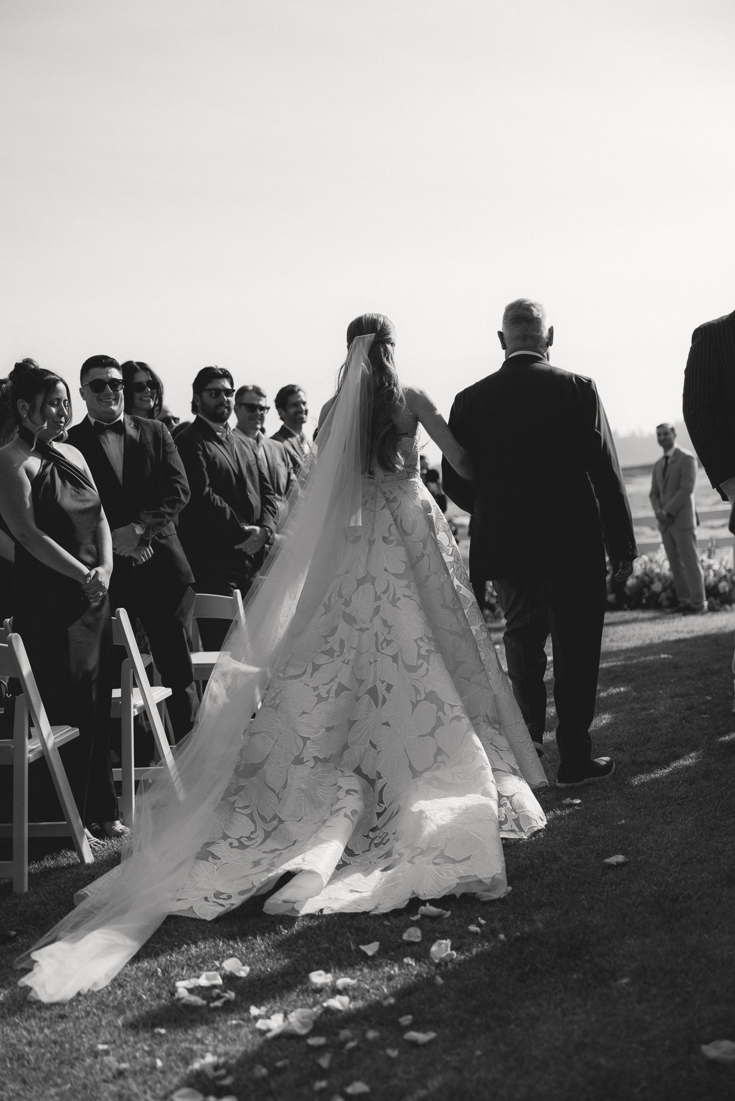 Bride walking down the aisle during a Mission Ranch wedding ceremony in Carmel, California, by Sammy Aucella Photography