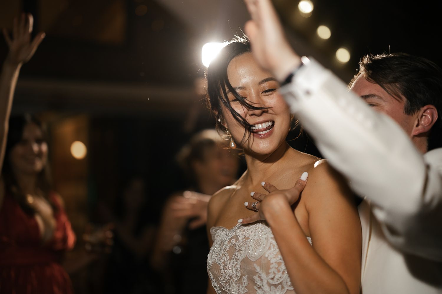 Bride dancing with champagne after an outfit change at a Glenbrook wedding on Lake Tahoe, by Sammy Aucella Photography