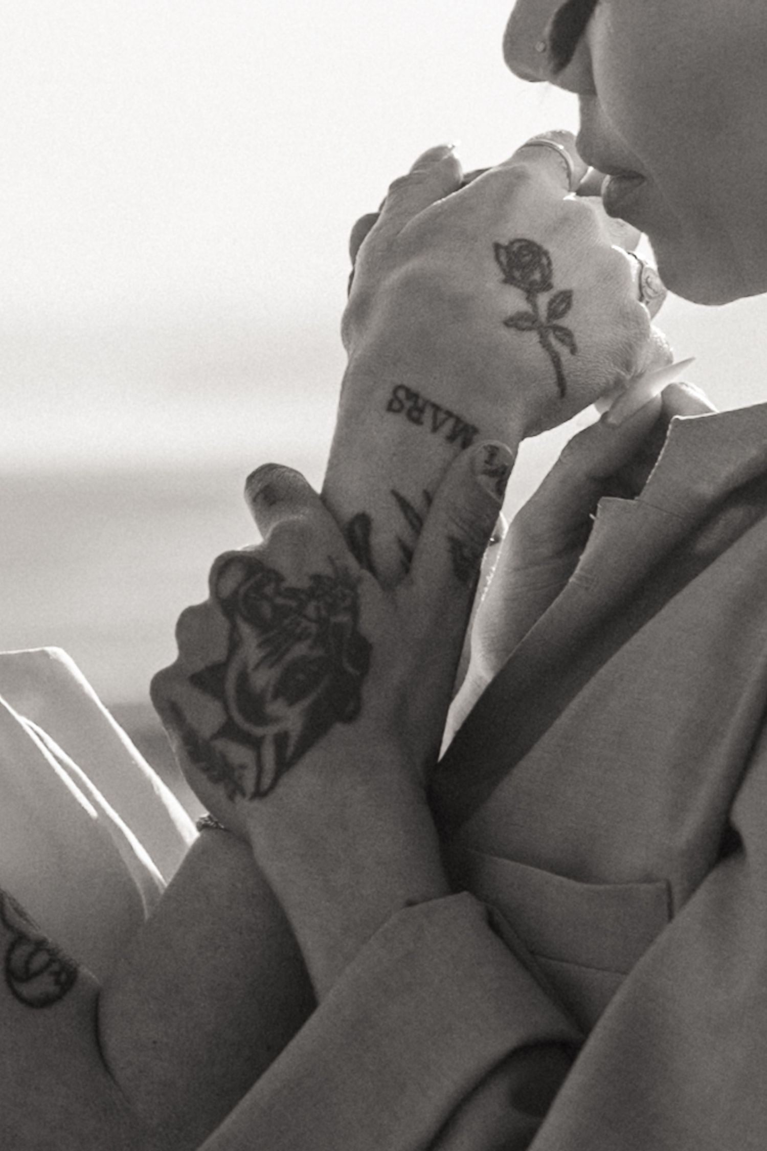 Black and white detail of the couple's tattooed hands, by Sammy Aucella Photography