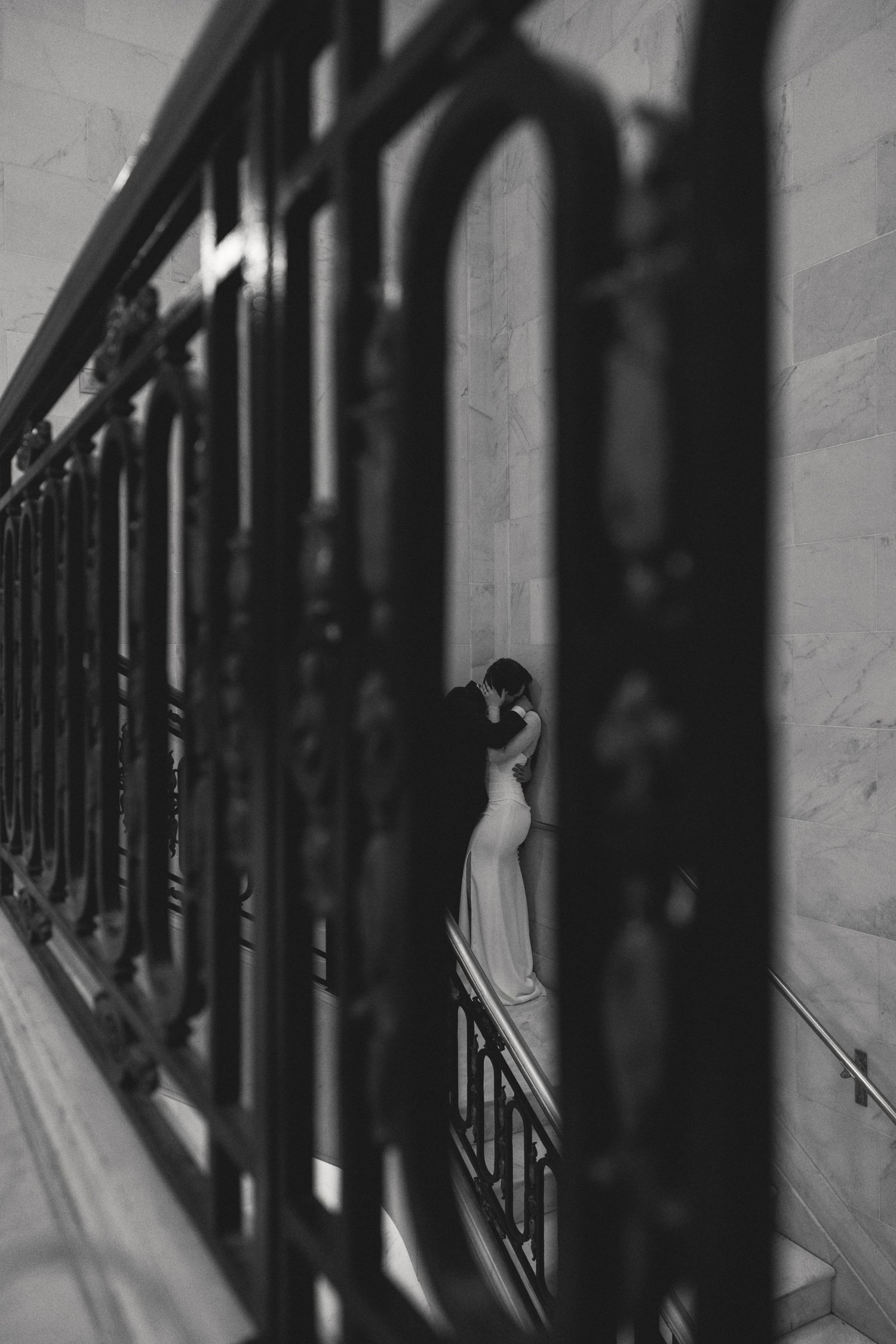 Bride beside a marble column at a San Francisco City Hall elopement, by Sammy Aucella Photography