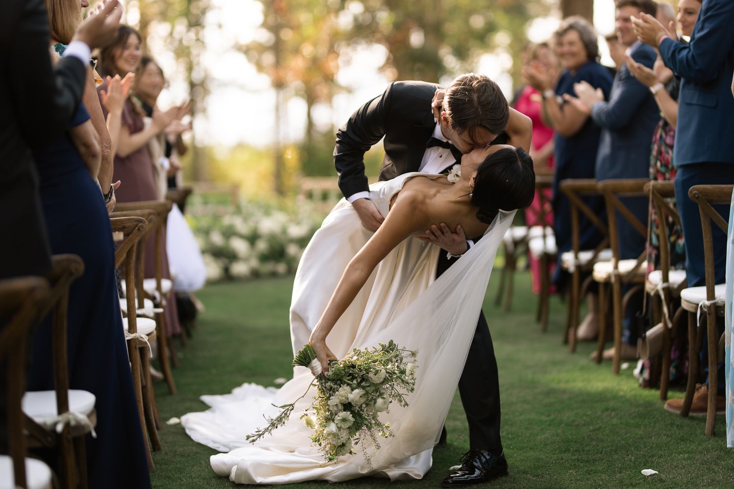Couple kissing as guests cheer at a Glenbrook reception on Lake Tahoe, California, by Sammy Aucella Photography