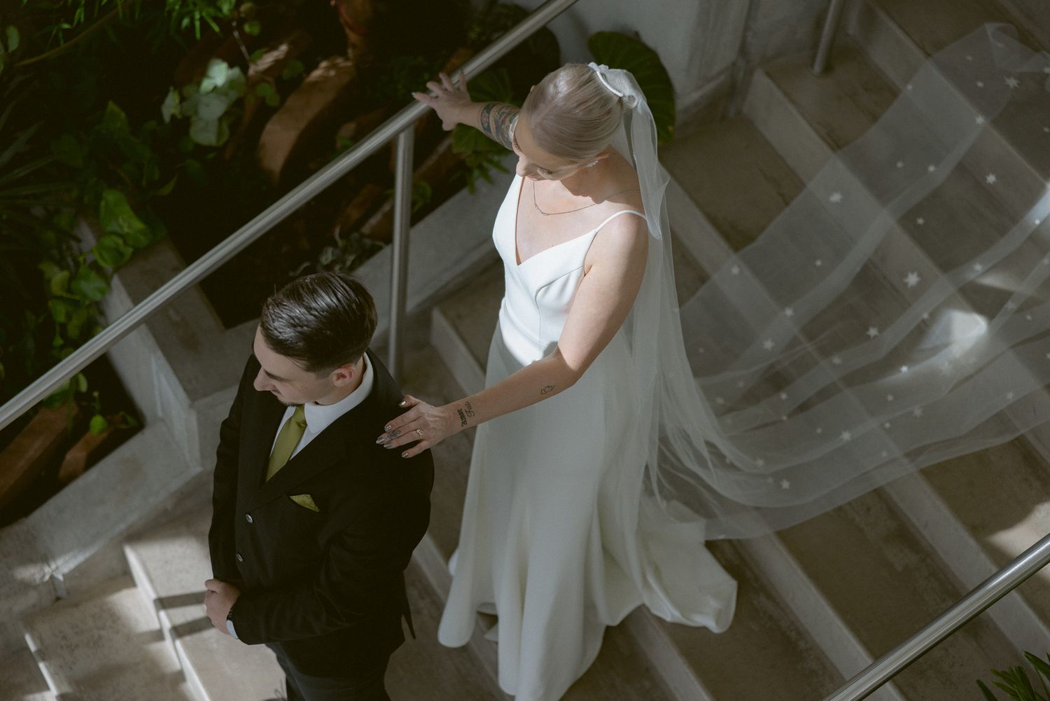Black and white first look on the staircase at a Red Butte Garden wedding in Salt Lake City, Utah, by Sammy Aucella Photography