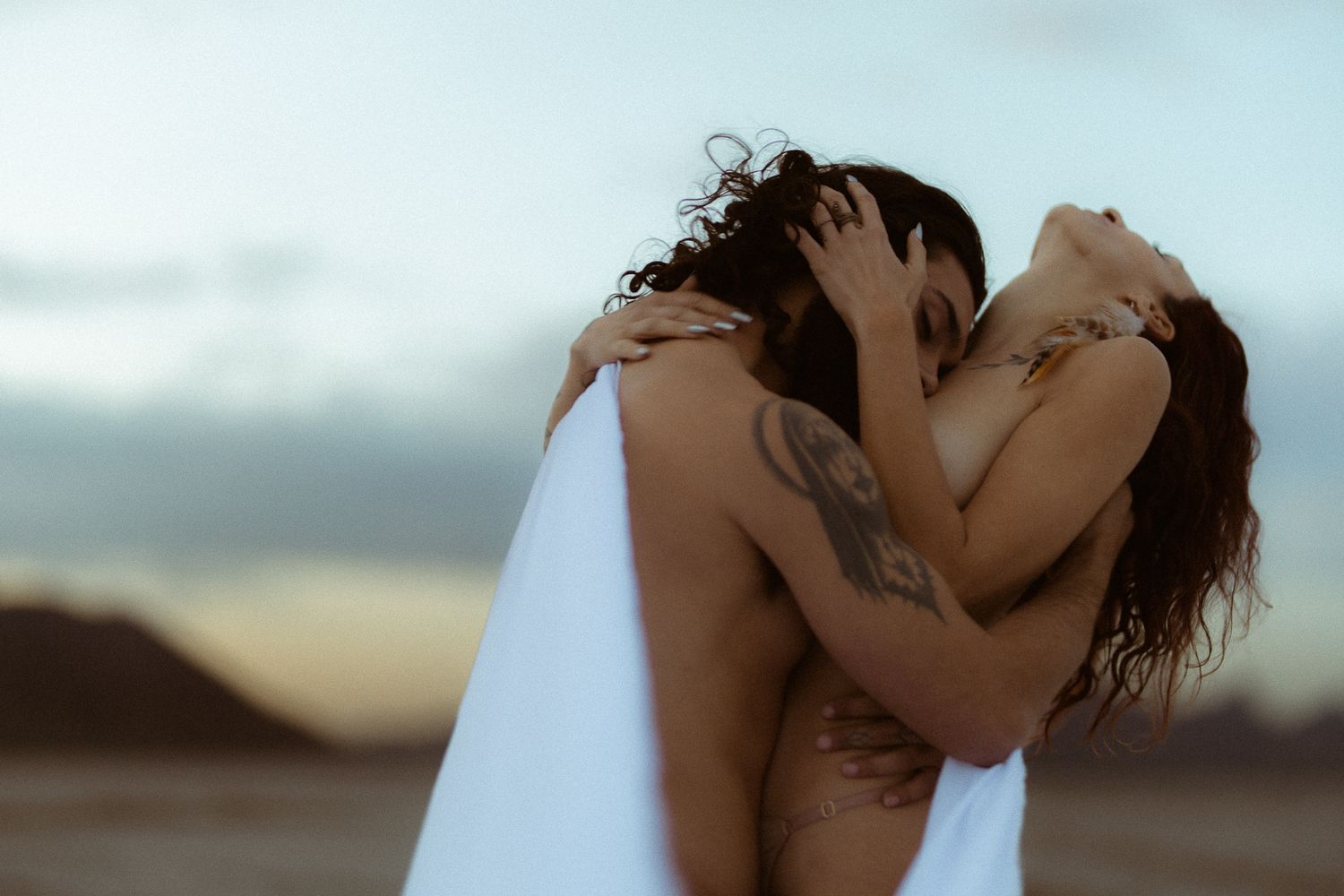 Tasteful nudity couple in love Bonneville Salt Flats in Salt Lake City, UT. Artistic Direction and photography by Sammy Aucella Photography.
