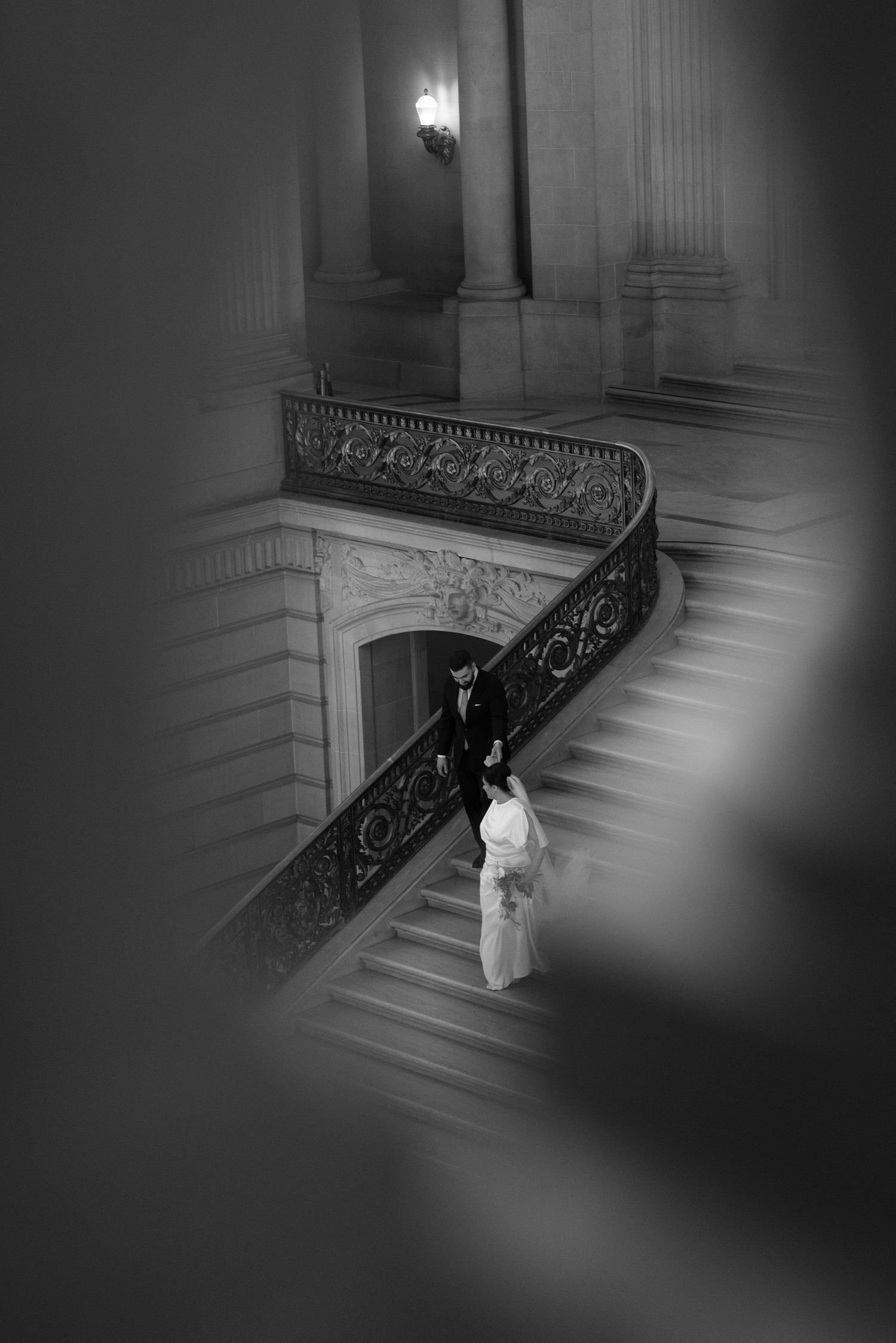 Bride on the grand staircase at a San Francisco City Hall elopement, by Sammy Aucella Photography