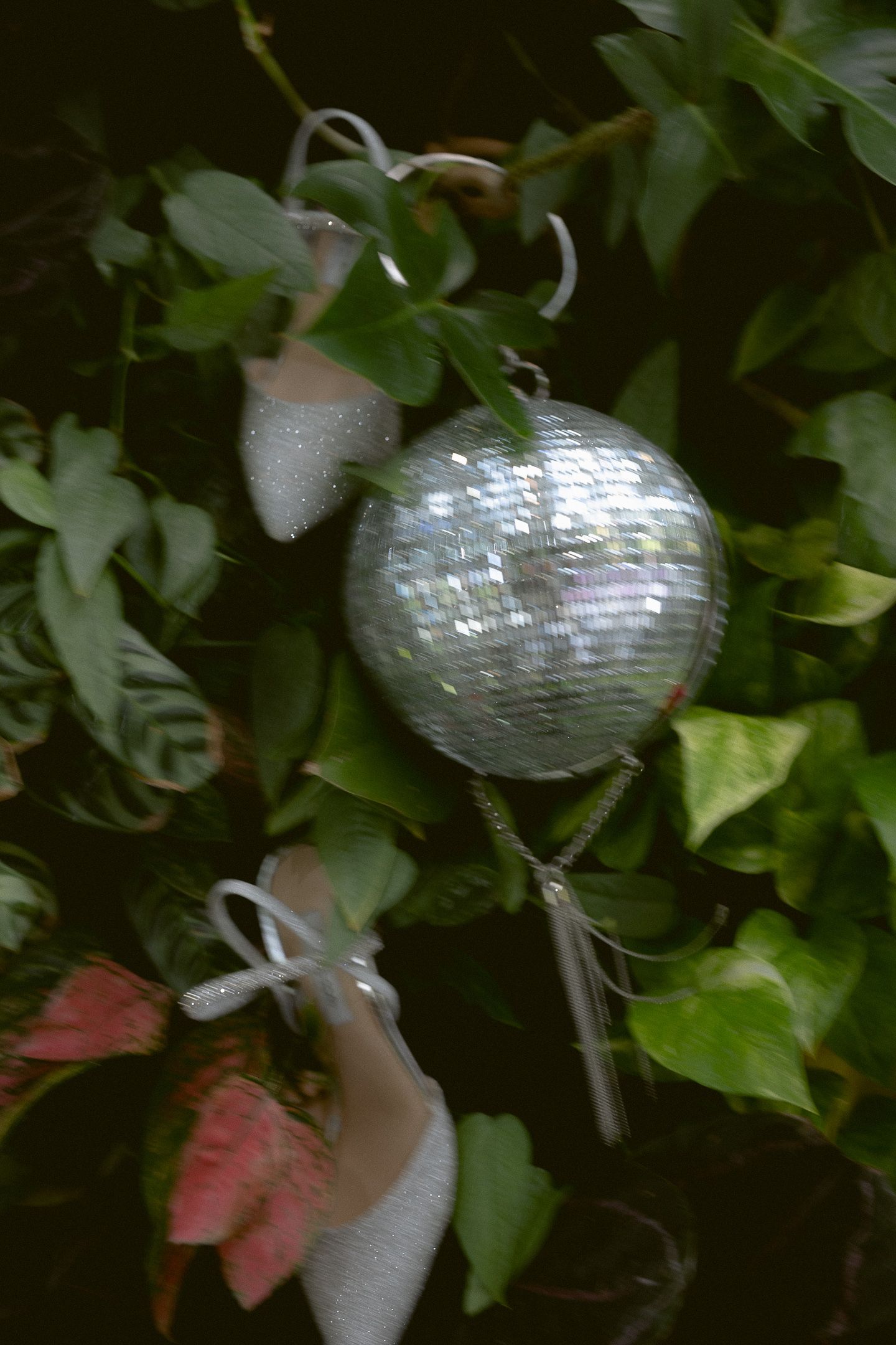 Artful disco ball detail in greenery at an Aspen, Colorado wedding, by Sammy Aucella Photography