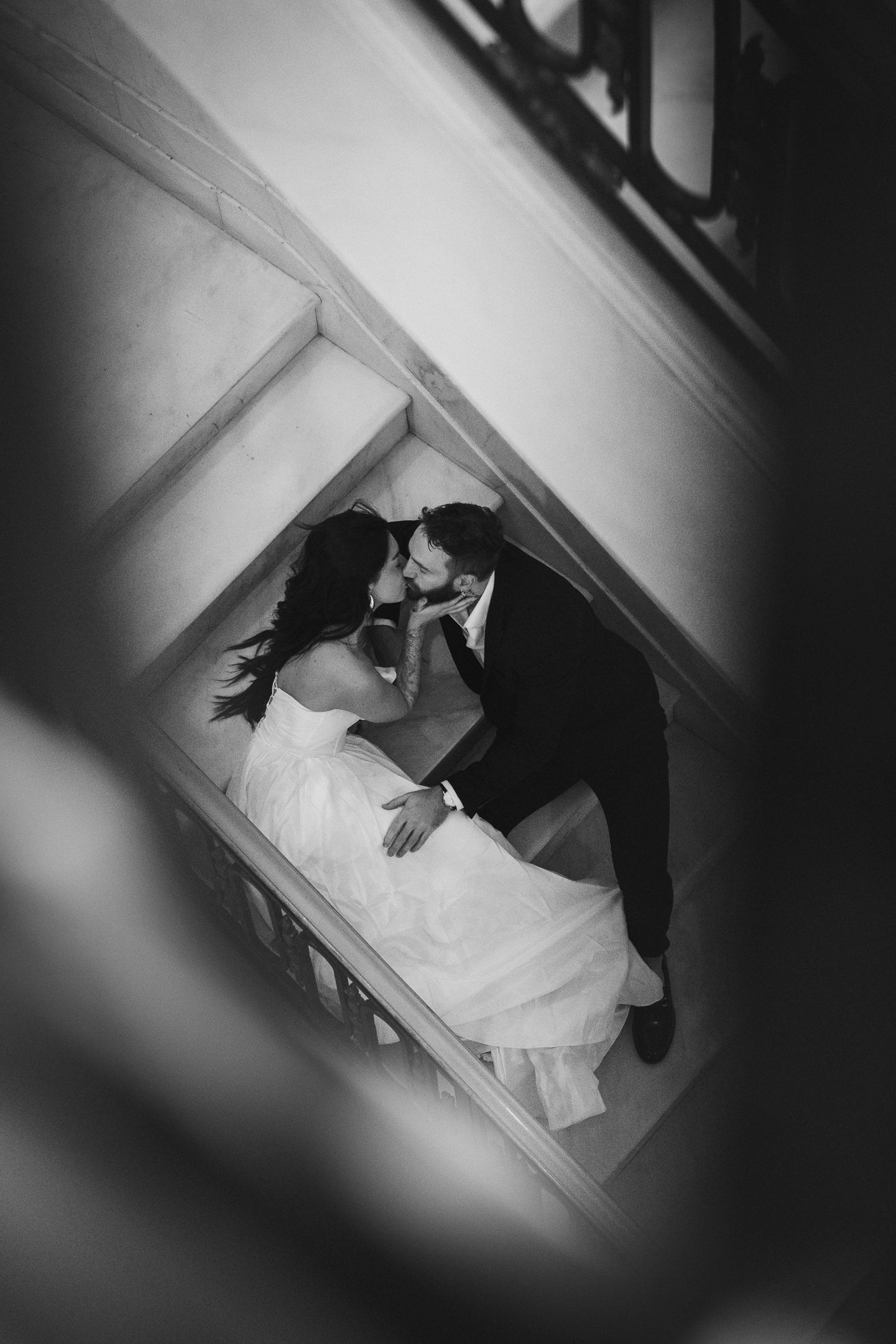 Black and white embrace in a window nook at a San Francisco City Hall elopement, by Sammy Aucella Photography