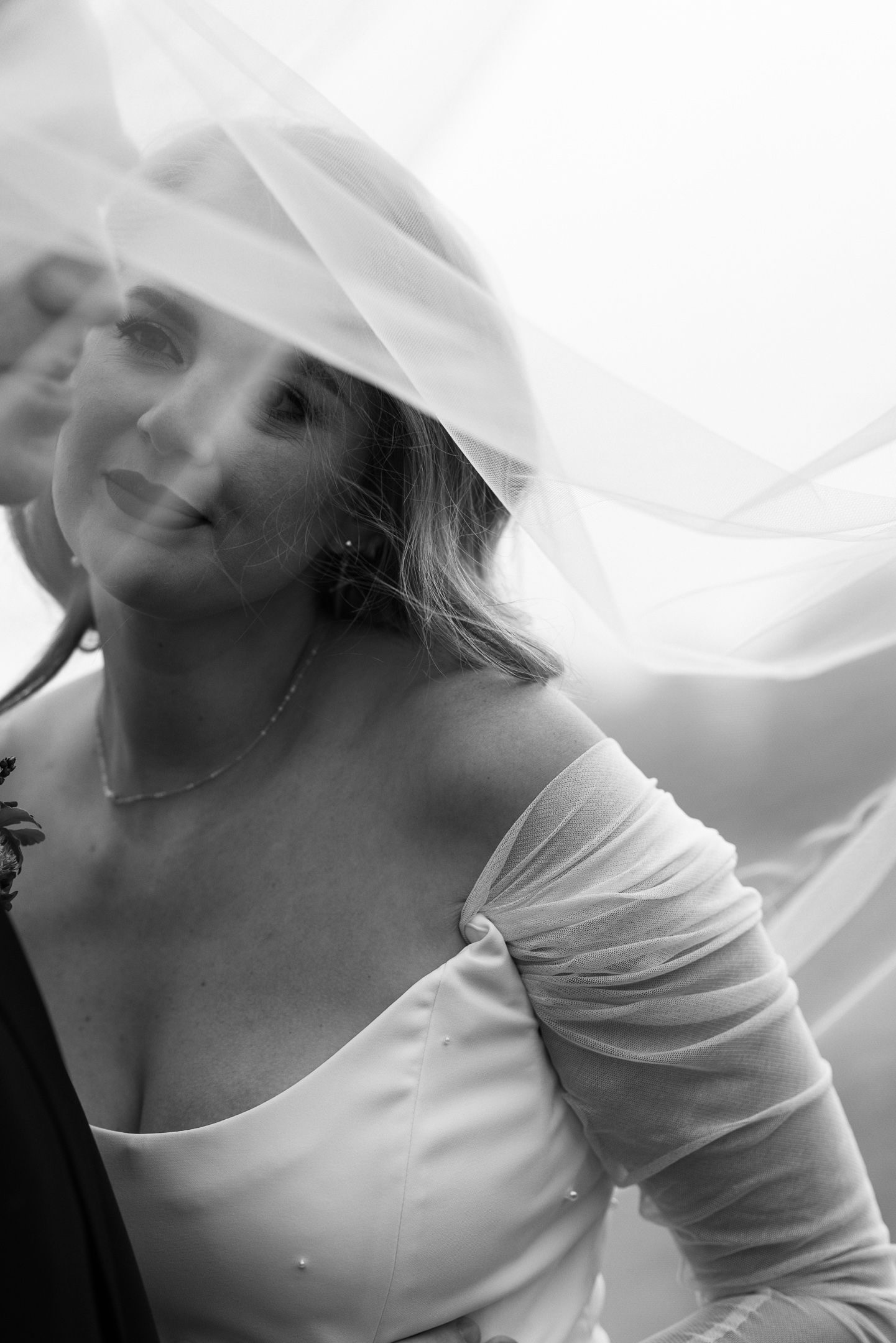 Soft black and white of the bride beneath her veil at a Cuffey's Cove wedding in Elk, Mendocino, by Sammy Aucella Photography